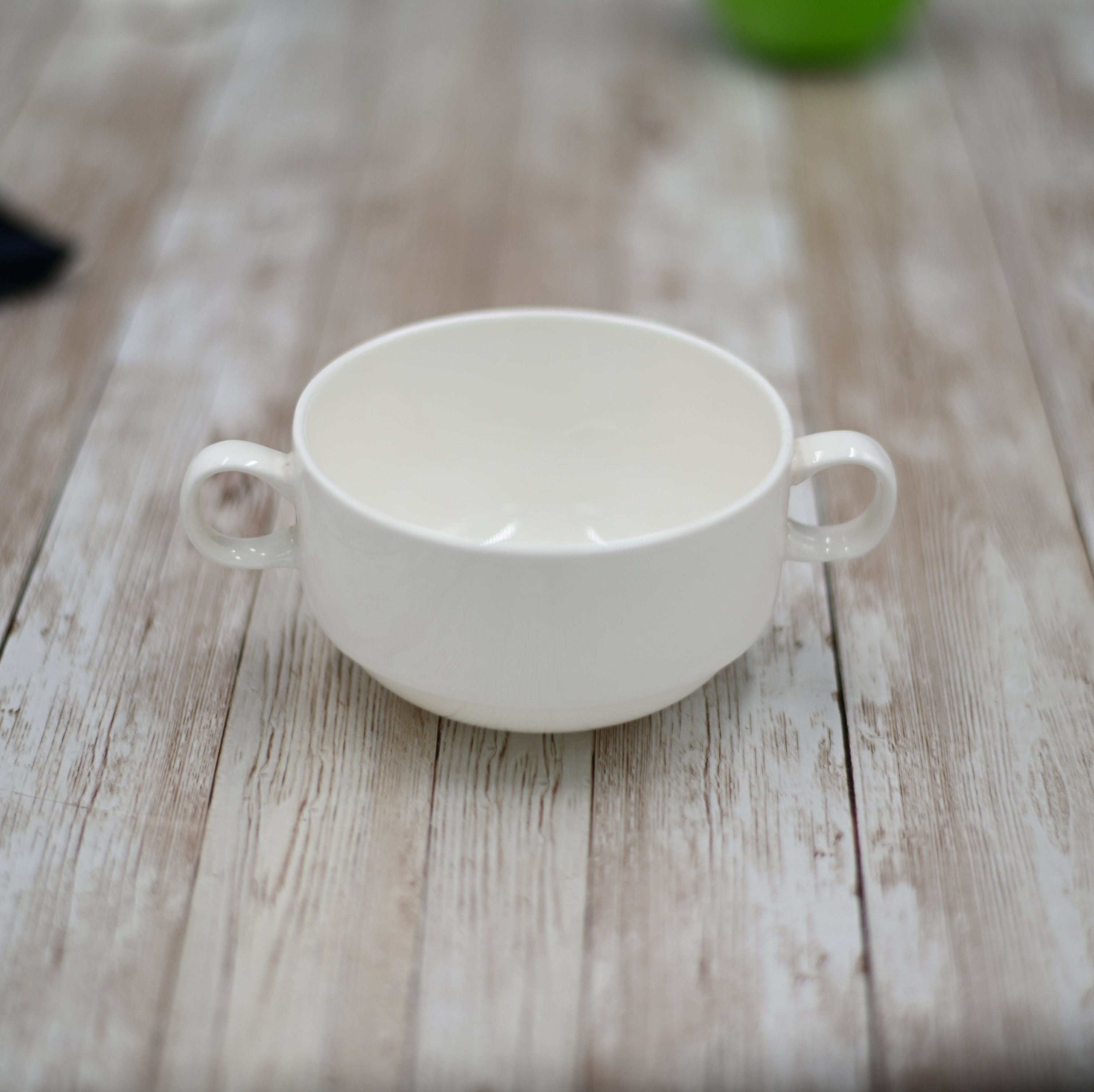 A stack of elegant white porcelain soup cups, each 4 inches in diameter, perfect for serving soups and stews.