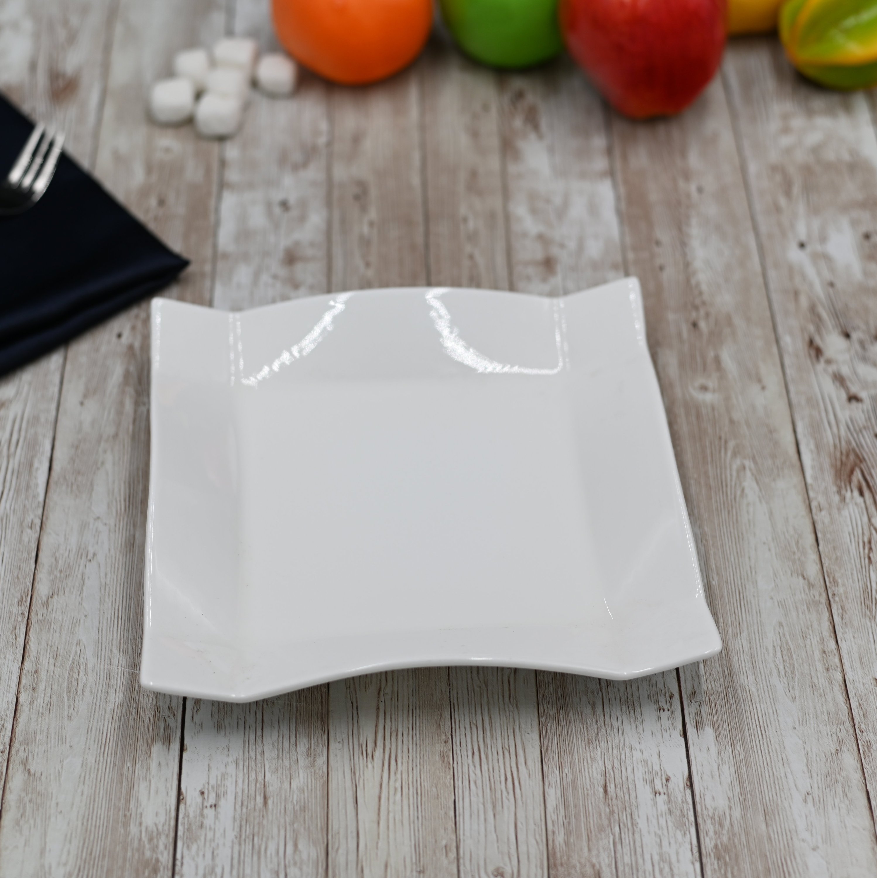 Elegant 8-inch white square dessert plate made of fine porcelain, showcasing a rolled rim design, perfect for serving desserts.