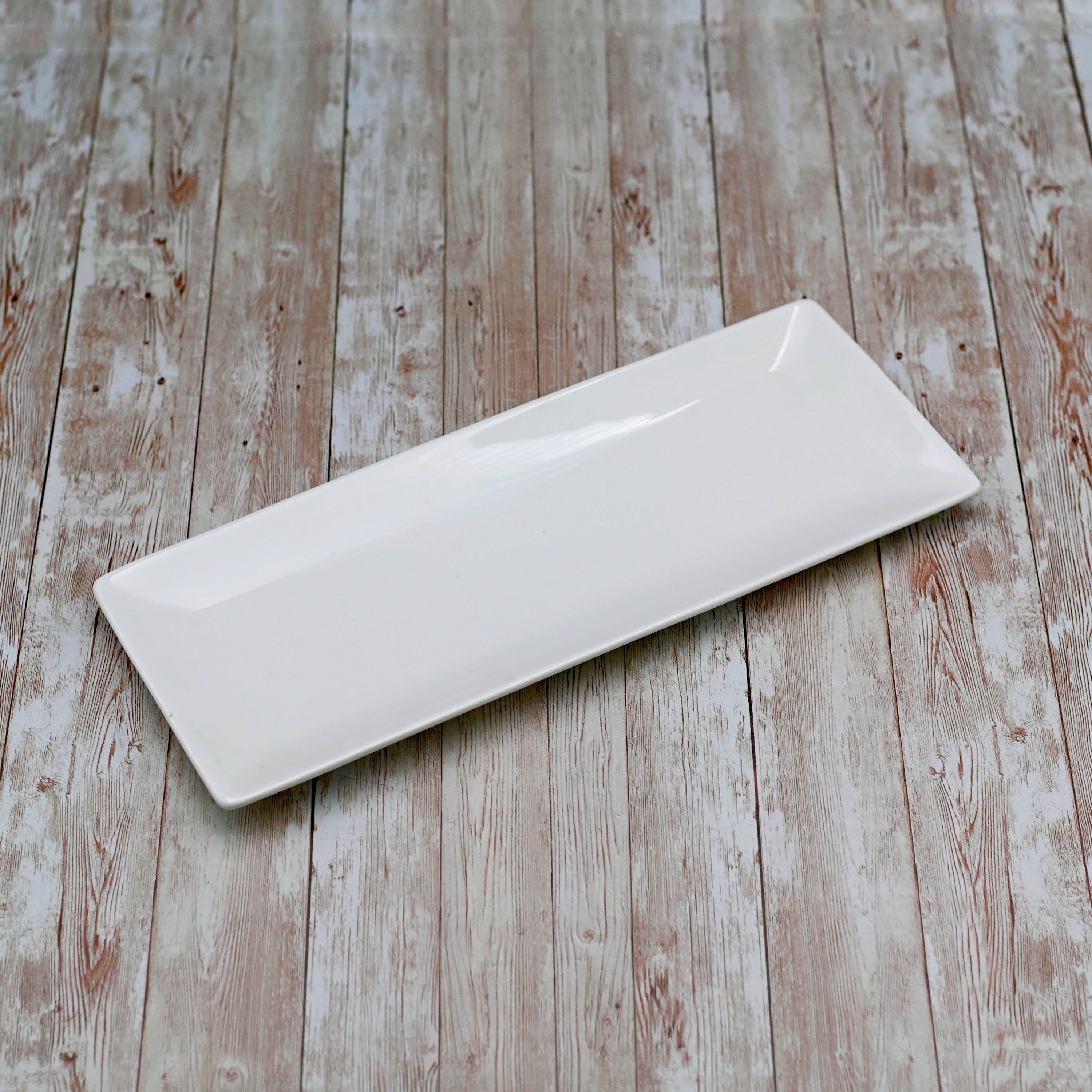 Elegant white porcelain sushi and canape dish, 12 inches by 4.7 inches, perfect for serving appetizers.