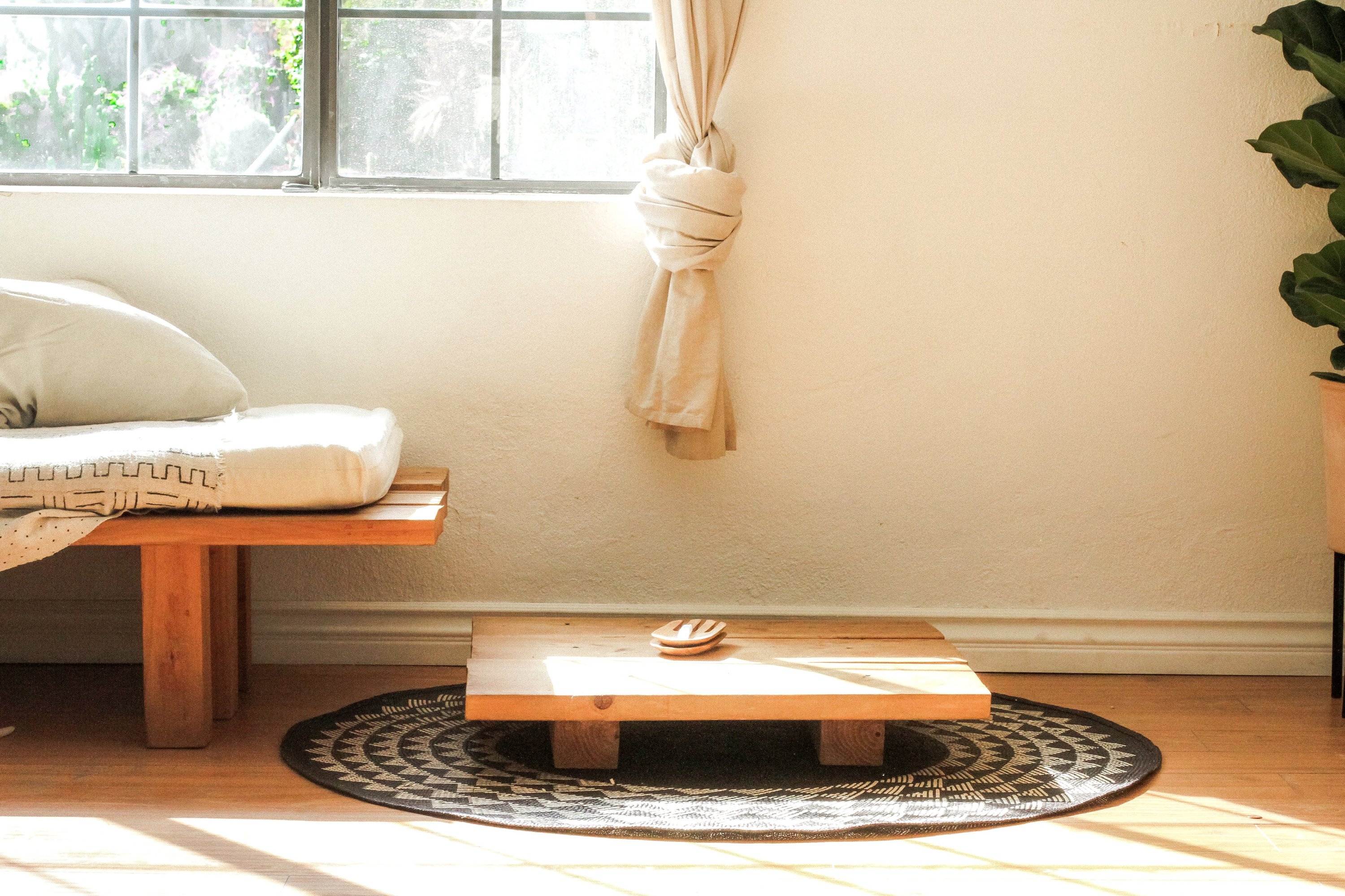 A 4-foot round White Triangle Mat featuring a natural base and white triangle pattern, perfect for indoor and outdoor use.