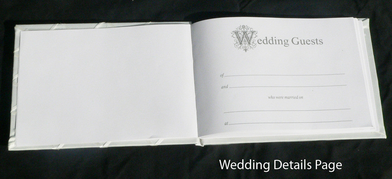 Elegant white wedding guest book set with a silver pen and matching stand, perfect for capturing guest messages.