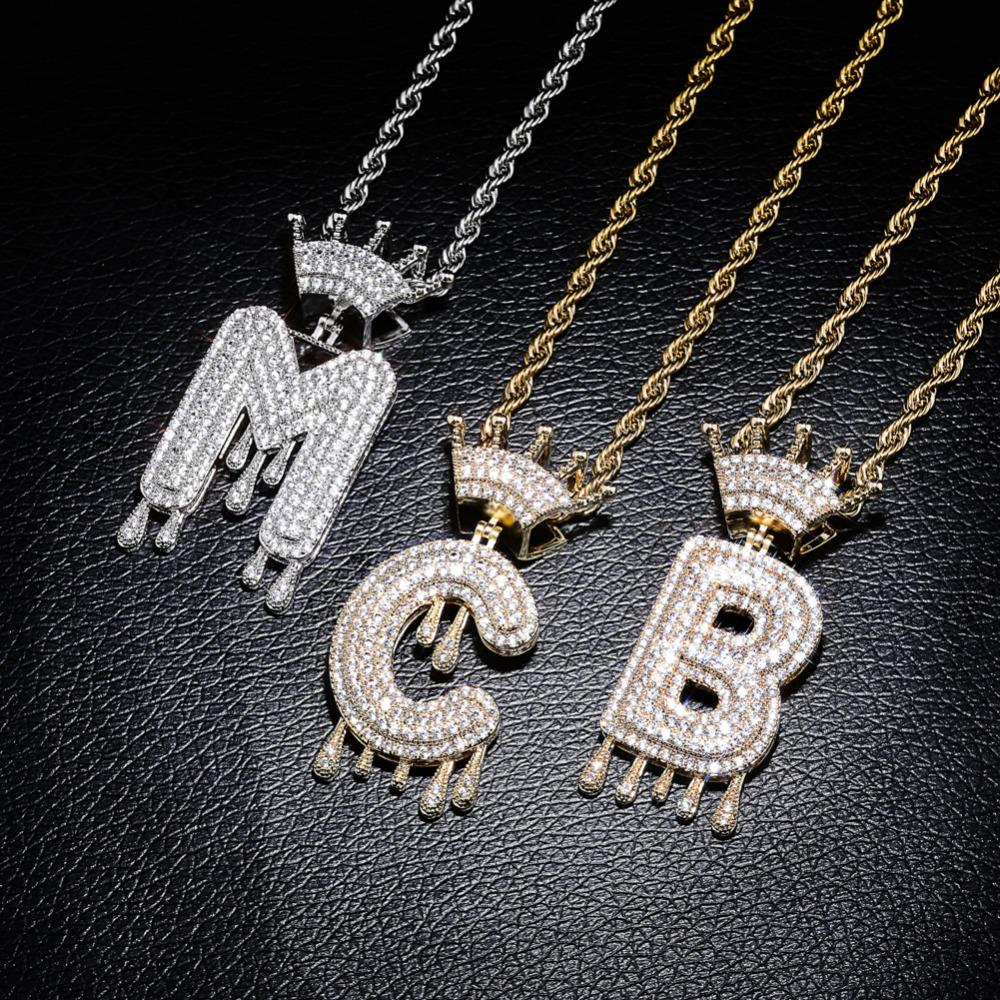 Wholesale Iced Out A-Z Crown Letter Pendant Necklace in rose gold and silver, featuring cubic zirconia stones and a rope chain.