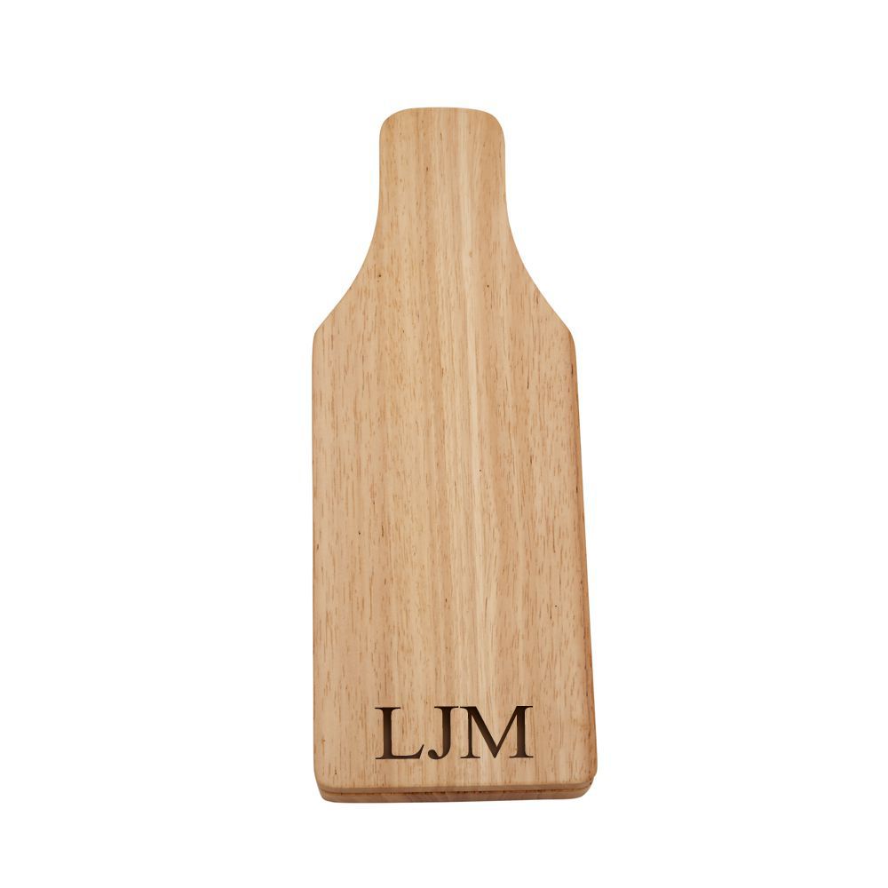 Wine bottle-shaped cheese board with sliding top revealing cheese knife, fork, and corkscrew, made of rubber wood.