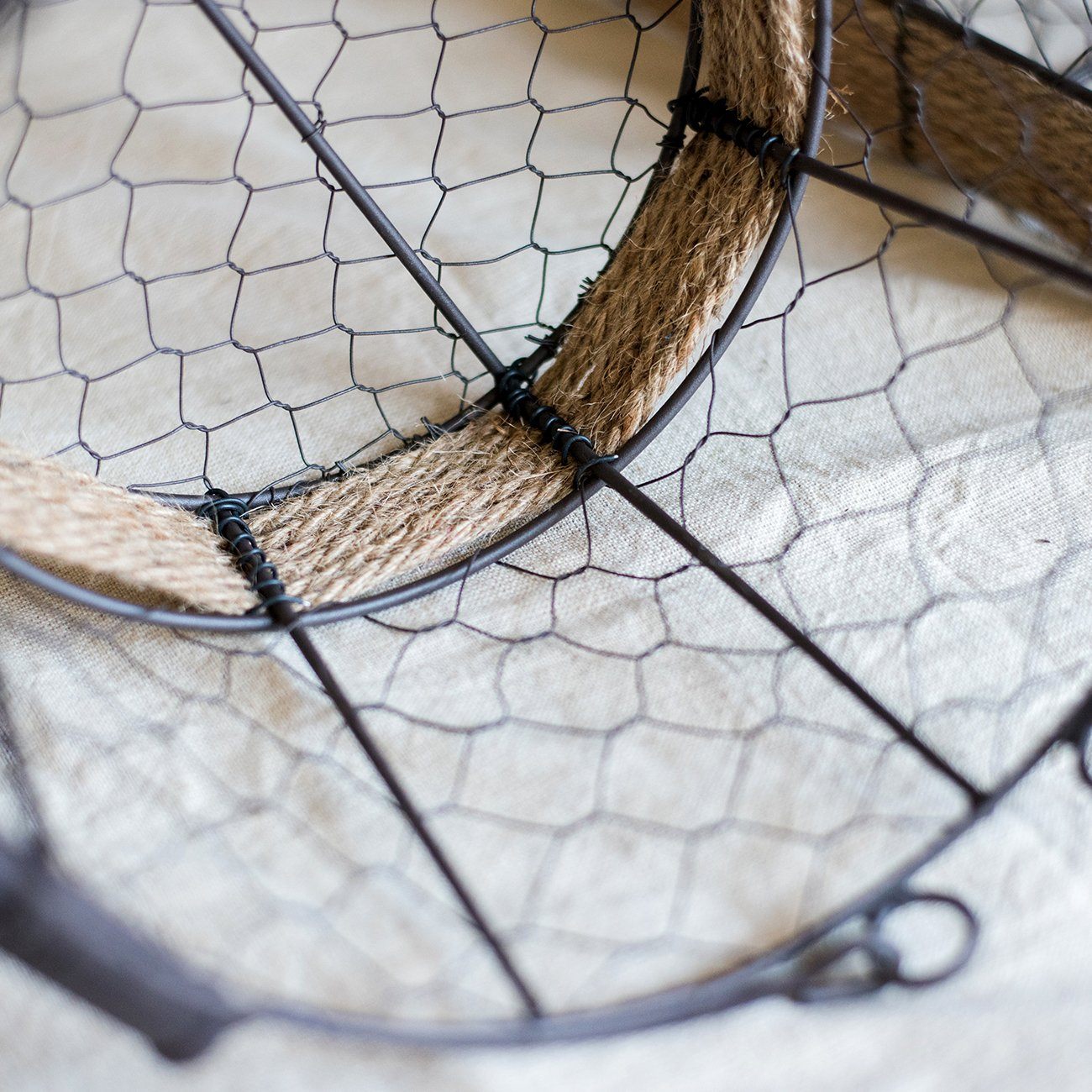 Wire Carry Basket with Hemp Rope Bottom, featuring a sturdy metal frame and natural hemp base, available in various colors.