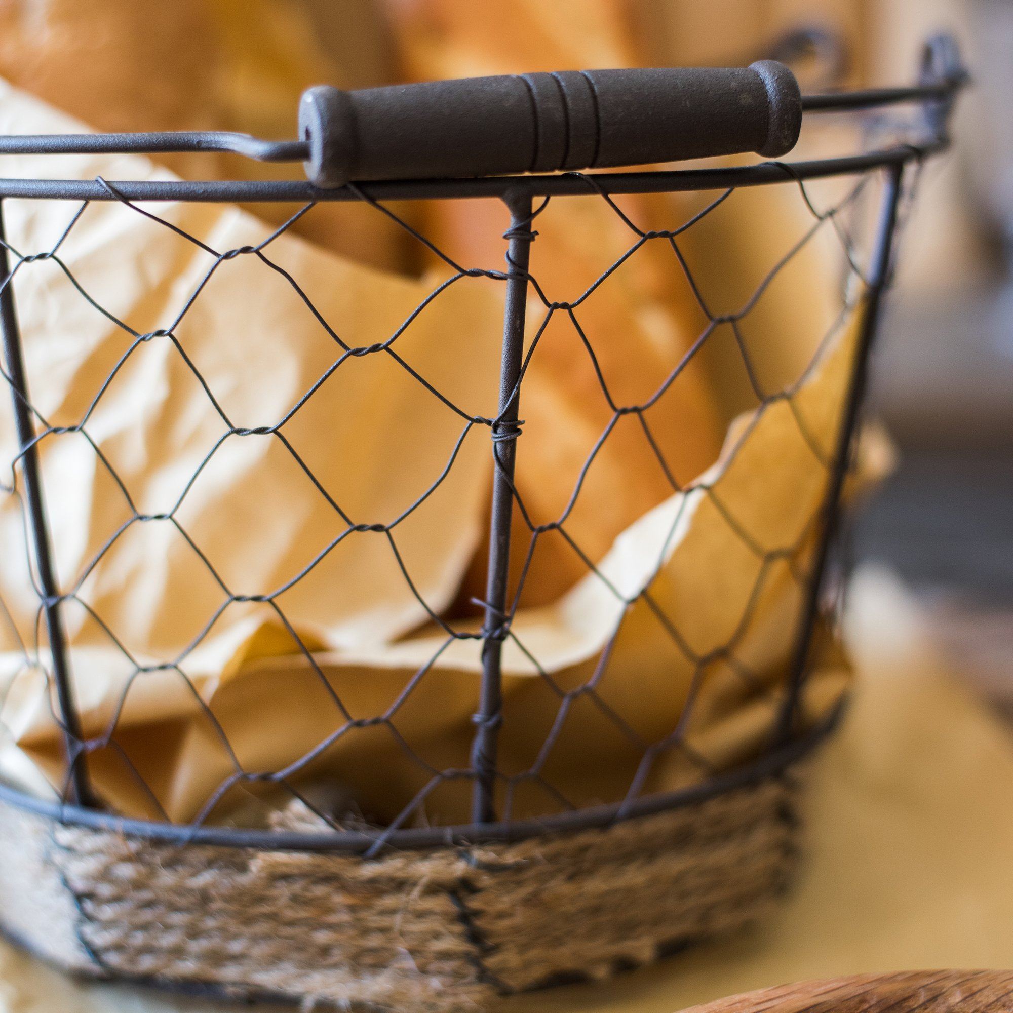 Wire Carry Basket with Hemp Rope Bottom, featuring a sturdy metal frame and natural hemp base, available in various colors.