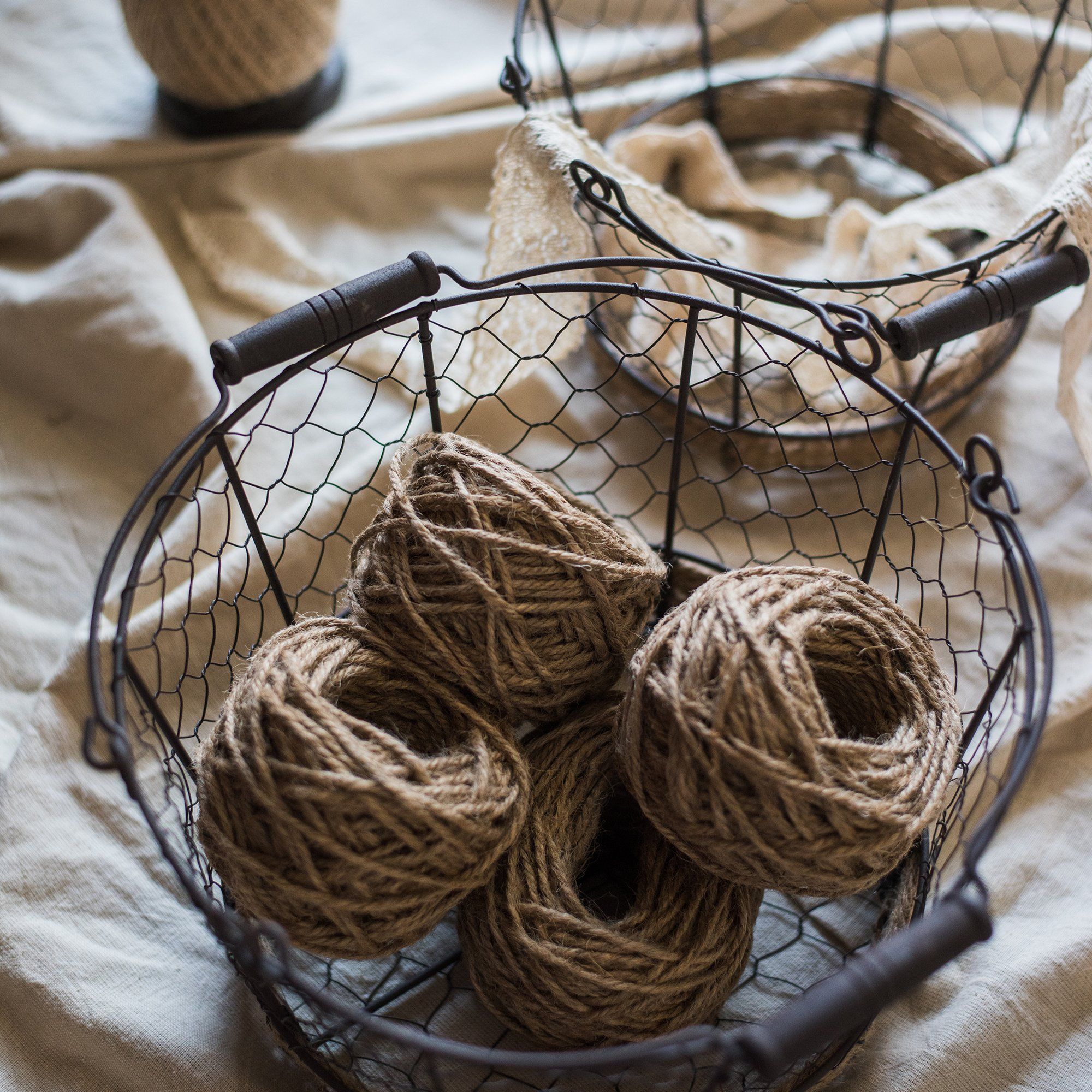 Wire Carry Basket with Hemp Rope Bottom, featuring a sturdy metal frame and natural hemp base, available in various colors.