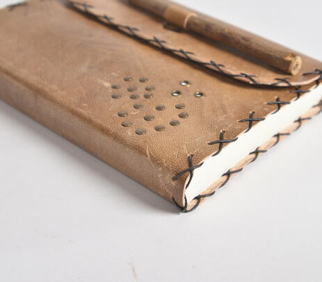 A beautifully handcrafted Wire Stitched Leather Diary with a vintage brown leather exterior and handmade paper pages, featuring a leather loop for holding pens.