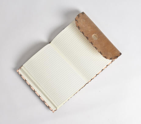 A beautifully handcrafted Wire Stitched Leather Diary with a vintage brown leather exterior and handmade paper pages, featuring a leather loop for holding pens.