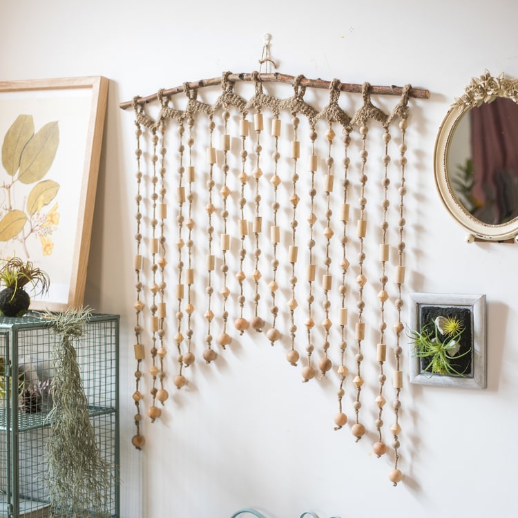 A beautifully crafted Wood Beaded Door Curtain made from solid wood beads and hemp rope, featuring a mix of beige, khaki, and brown colors.