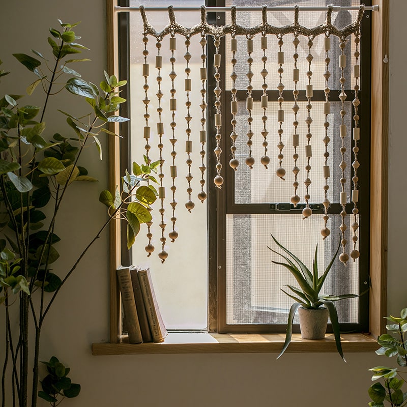 A beautifully crafted Wood Beaded Door Curtain made from solid wood beads and hemp rope, featuring a mix of beige, khaki, and brown colors.