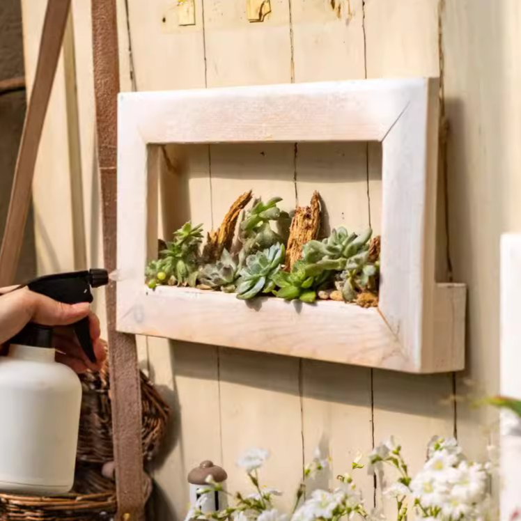 Wood Hanging Floral Frame in white, showcasing plants elegantly on a wall.