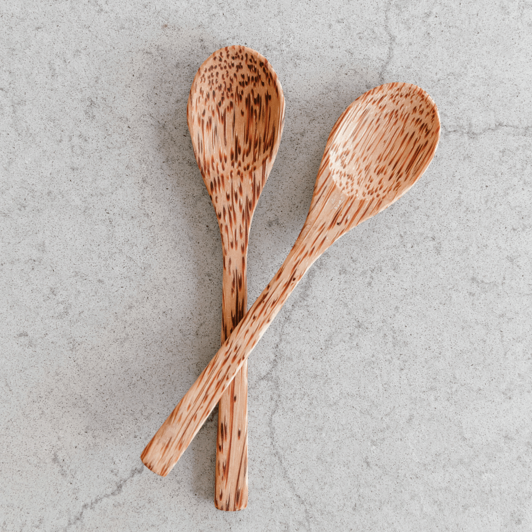 A beautifully handcrafted Wooden Coconut Spoon made from natural coconut shell, showcasing its unique grain and smooth finish.