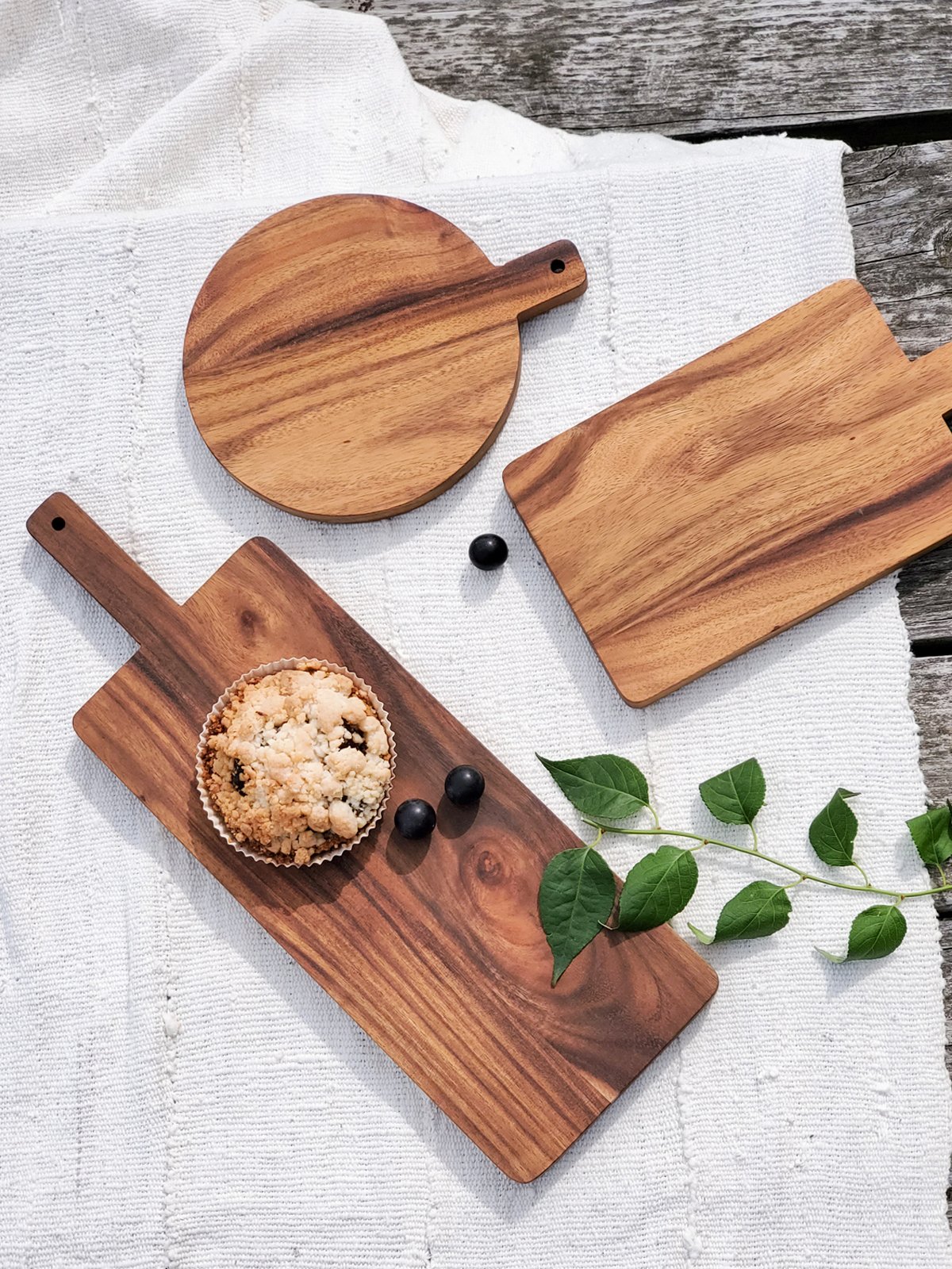 Large handcrafted wooden serving board made from Albizia hardwood, showcasing unique grain patterns and natural finish.