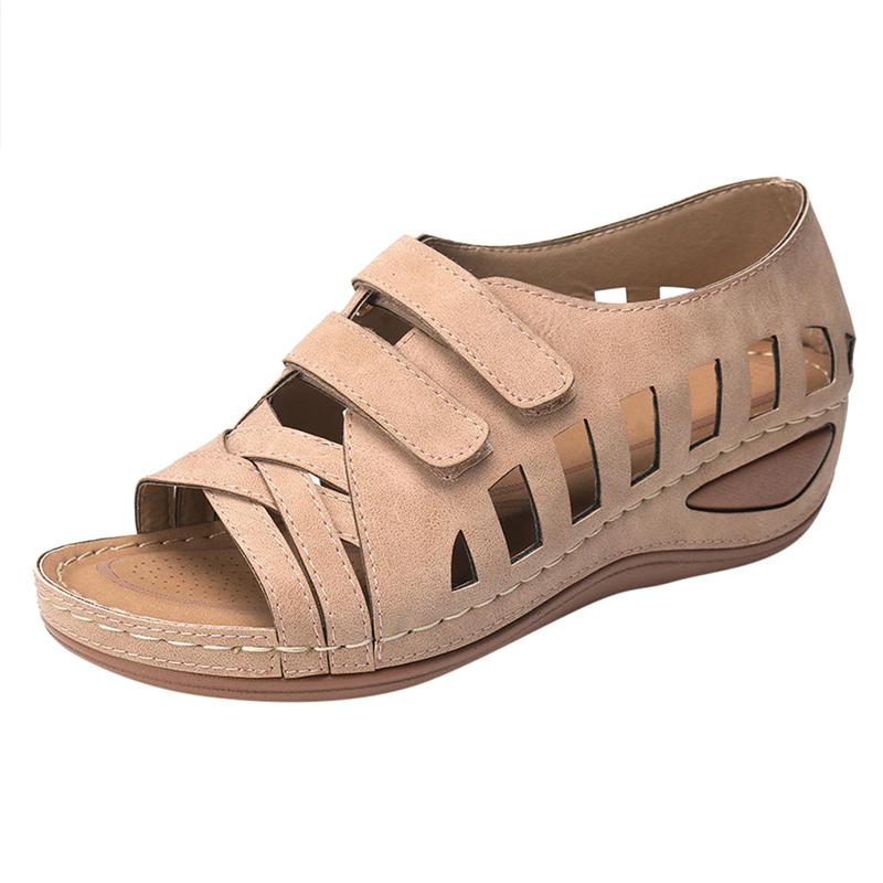 A pair of stylish women sandals featuring soft leather upper, wedge heel, and open side vamp, perfect for summer wear.