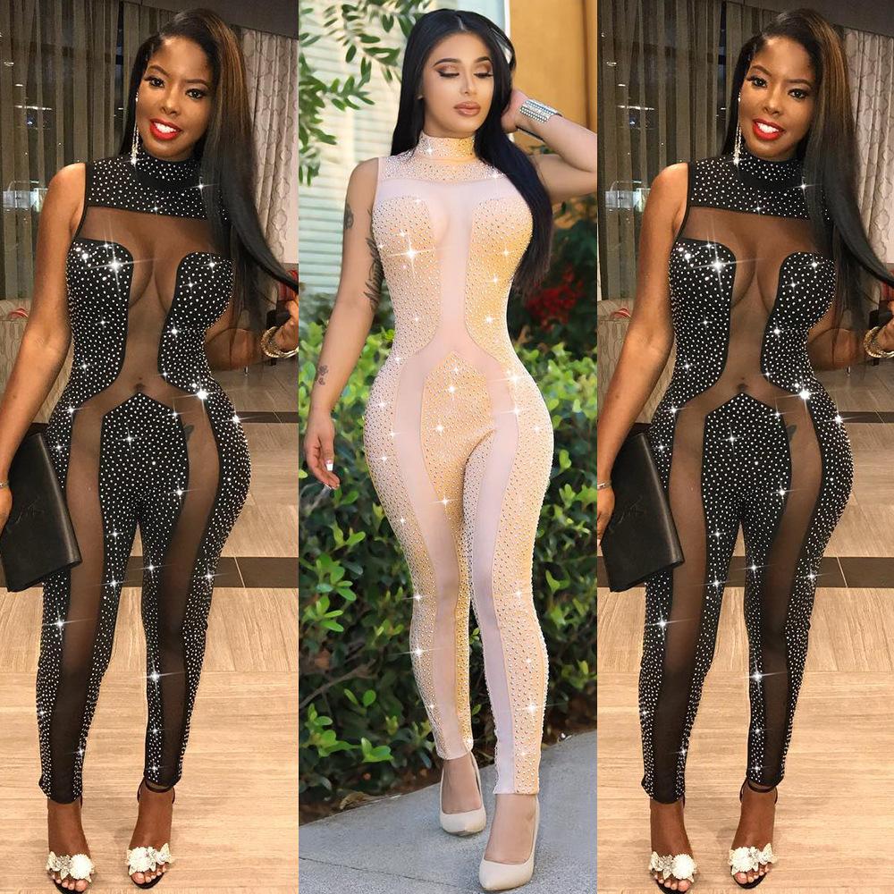 Women Sexy Rhinestone Sheer Jumpsuit featuring a high neck and sleeveless design with polka dot pattern and rhinestone embellishments.