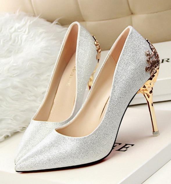 Stylish women's high-heeled suede shoes with carved metal heel and pointed toe, perfect for weddings.