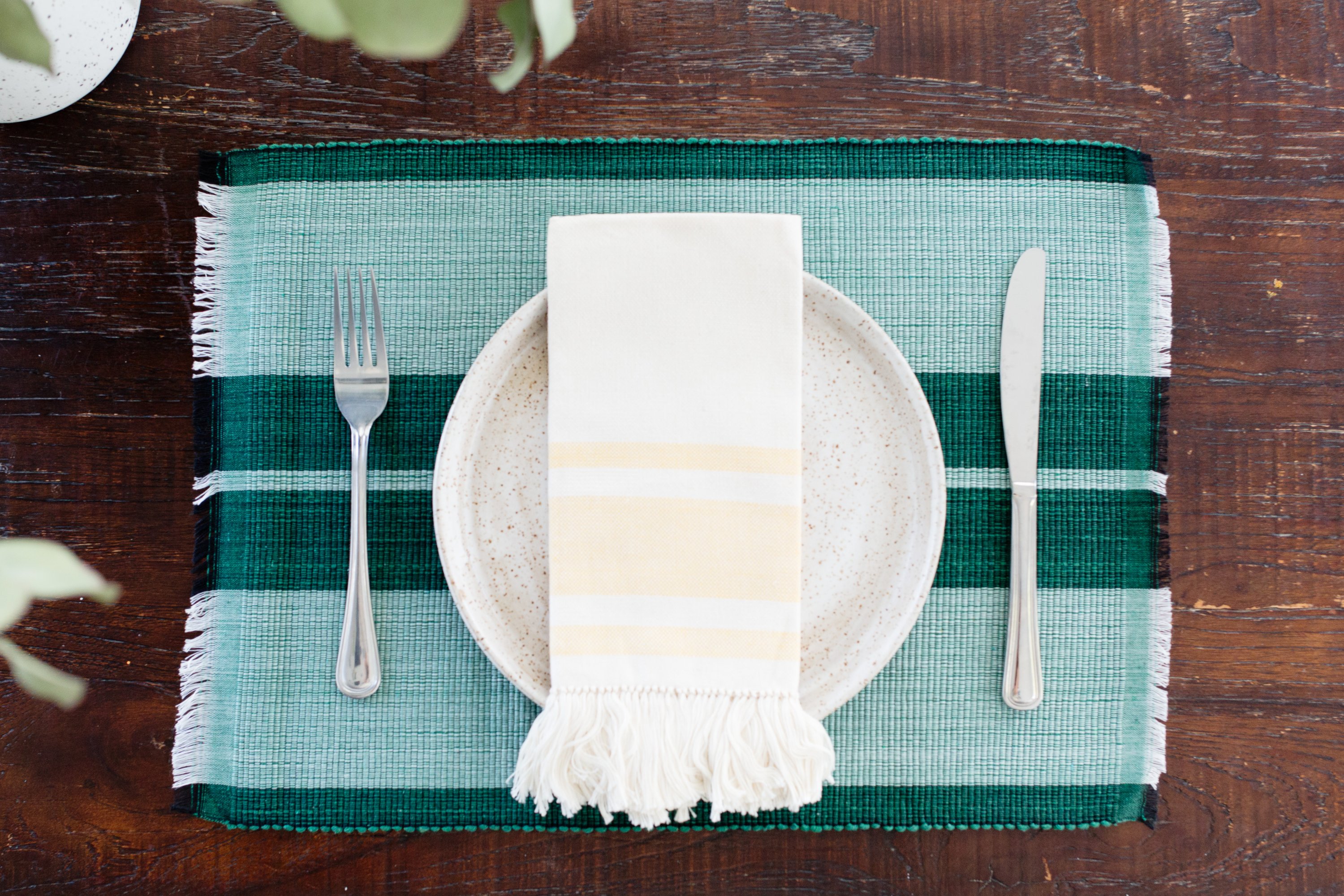 Handcrafted forrest green woven cotton dining placemat showcasing raised ribbed patterns, perfect for enhancing table settings.