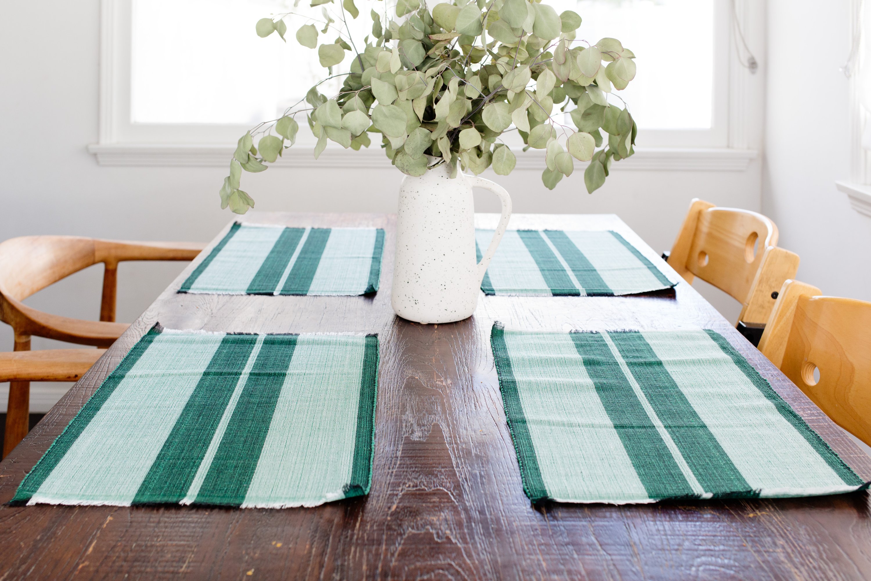 Handcrafted forrest green woven cotton dining placemat showcasing raised ribbed patterns, perfect for enhancing table settings.