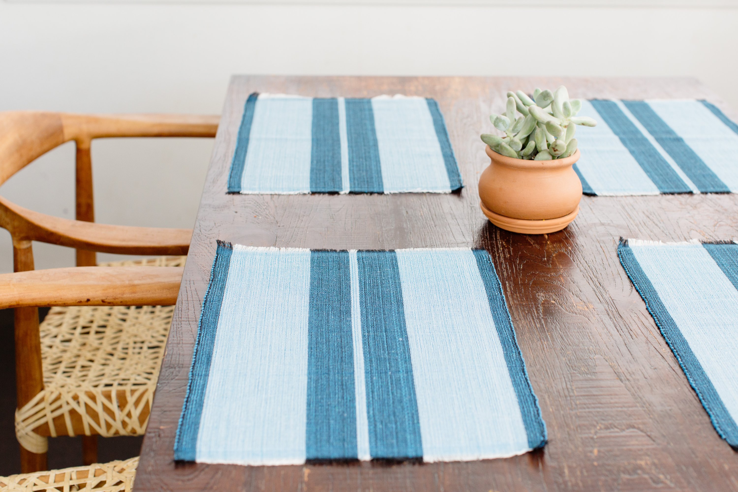 Ocean blue woven cotton dining placemat with raised ribbed patterns, handcrafted by local artisans.