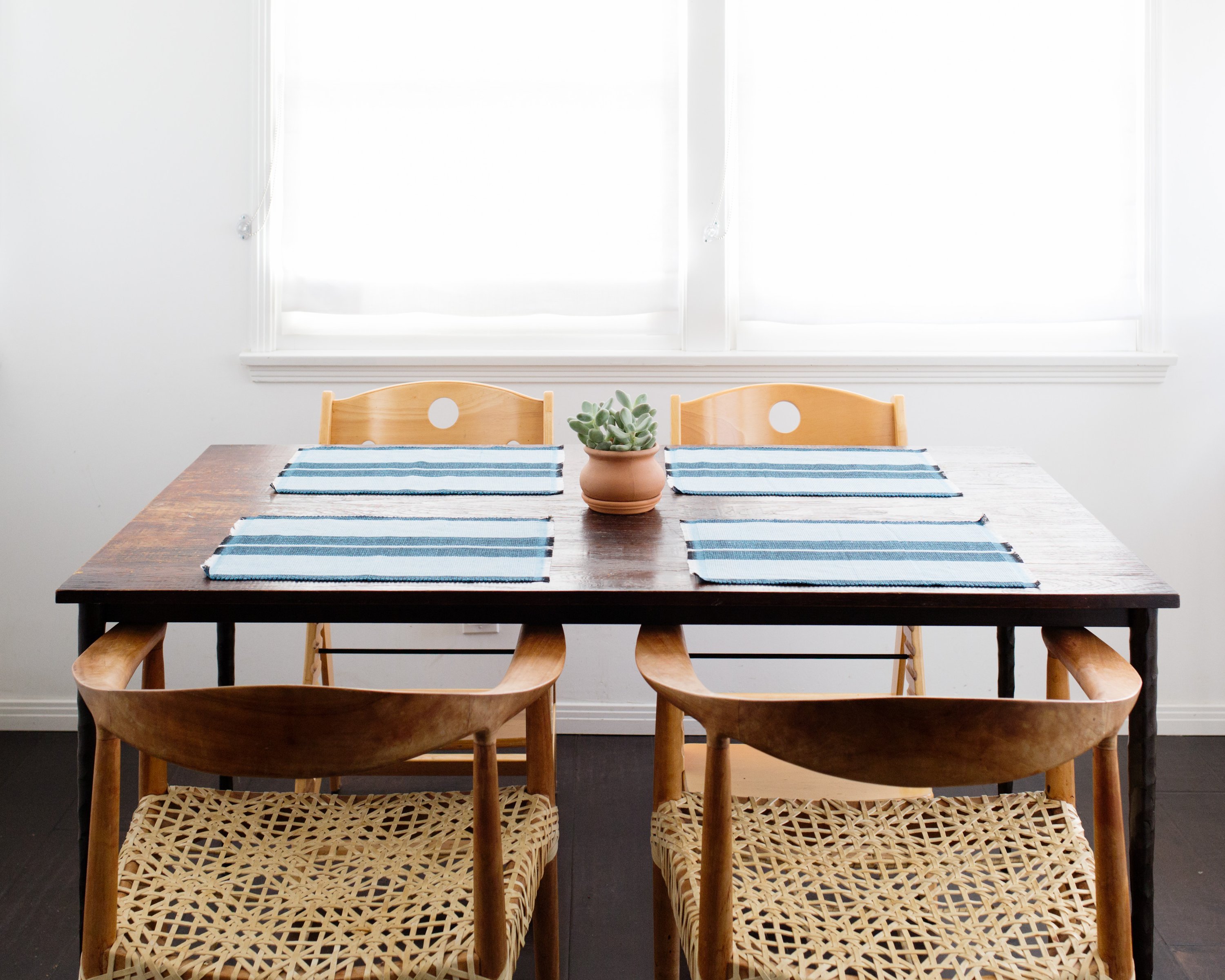 Ocean blue woven cotton dining placemat with raised ribbed patterns, handcrafted by local artisans.