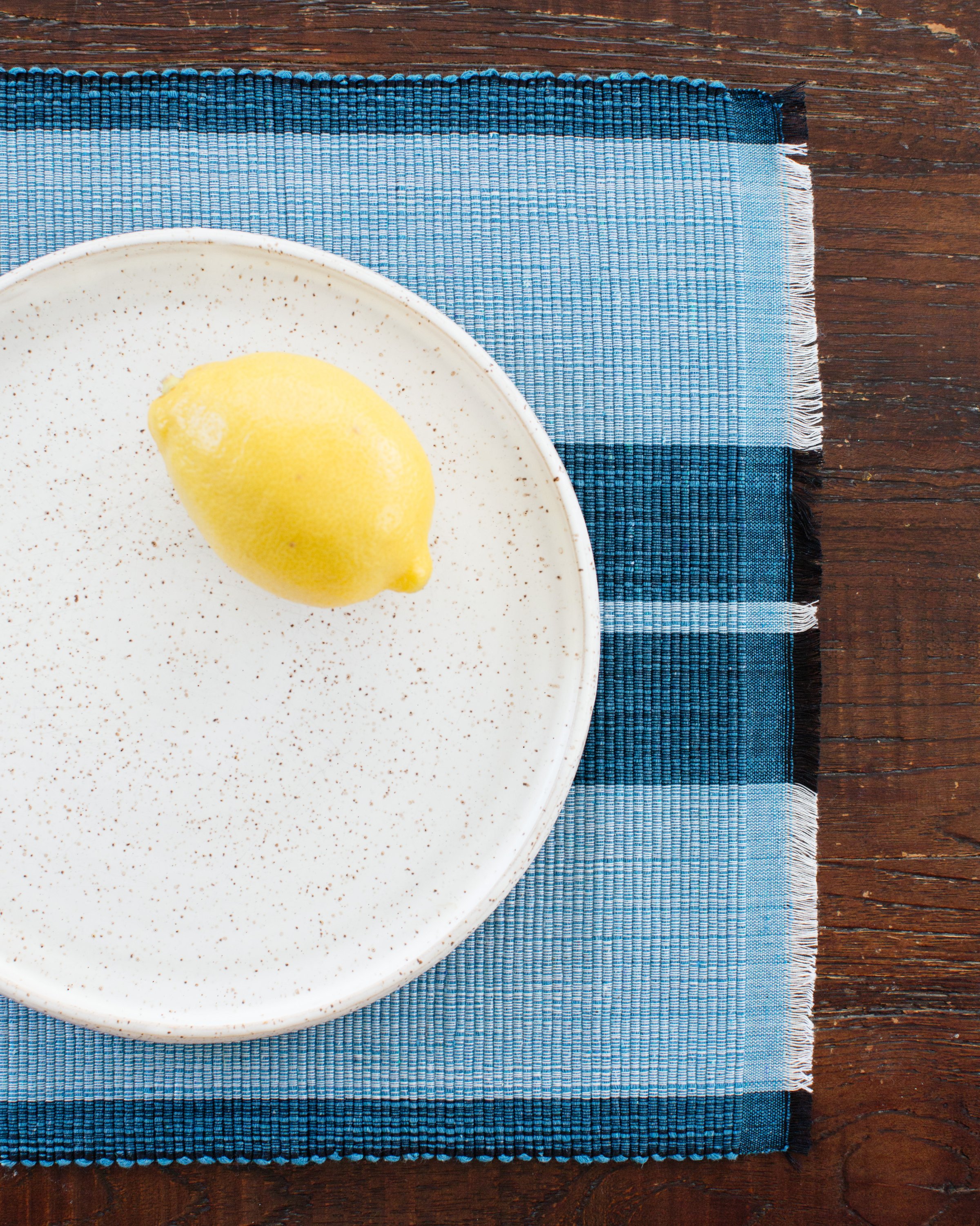 Ocean blue woven cotton dining placemat with raised ribbed patterns, handcrafted by local artisans.