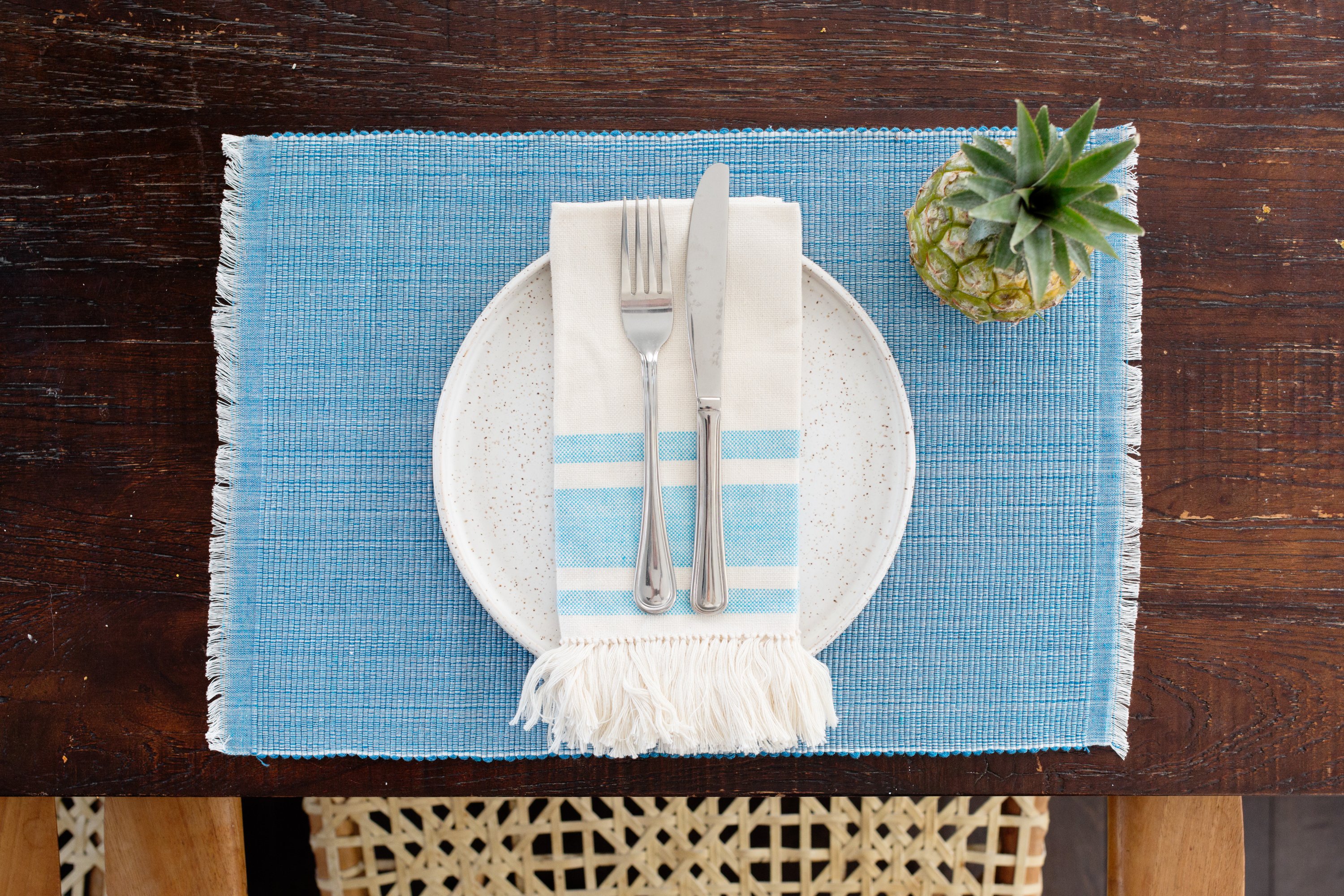 Handcrafted pastel blue woven cotton dining placemat featuring raised ribbed patterns, showcasing traditional Inabel fabric.