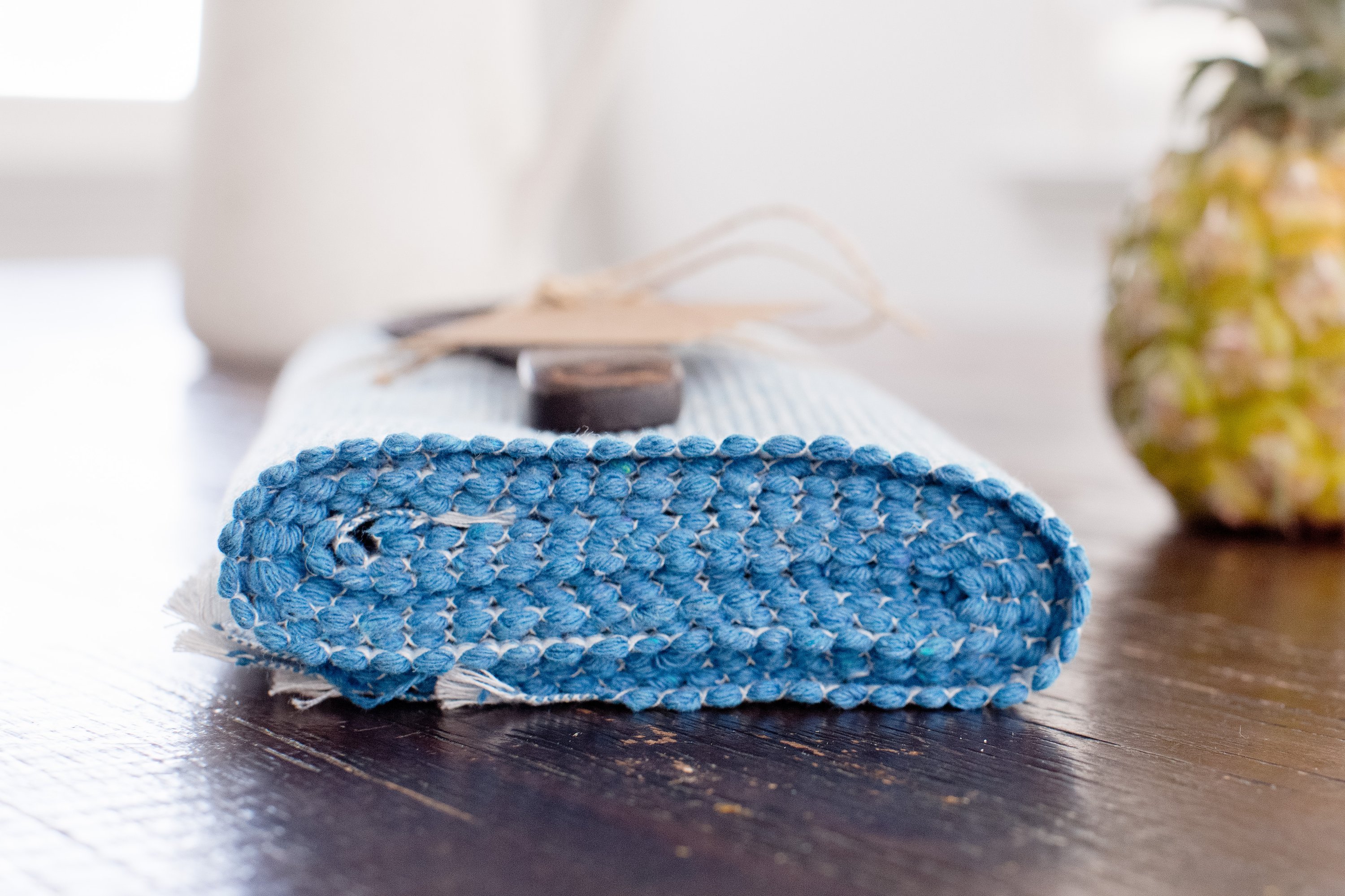 Handcrafted pastel blue woven cotton dining placemat featuring raised ribbed patterns, showcasing traditional Inabel fabric.