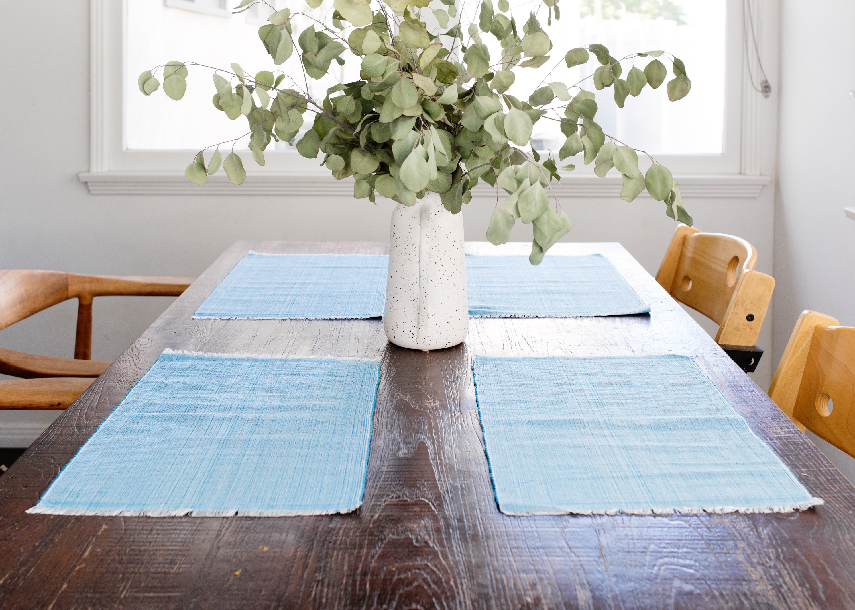 Handcrafted pastel blue woven cotton dining placemat featuring raised ribbed patterns, showcasing traditional Inabel fabric.