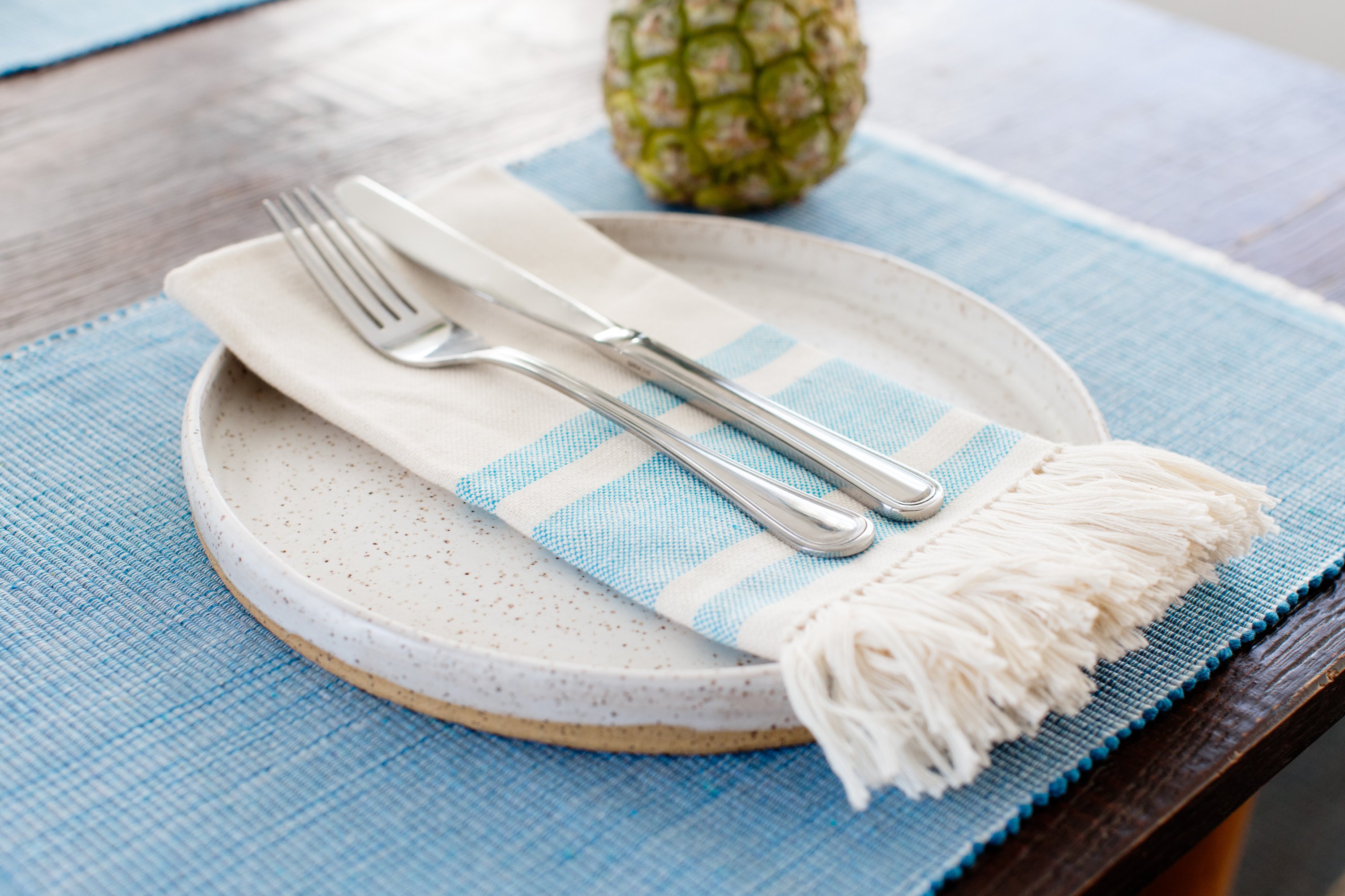 Handcrafted pastel blue woven cotton dining placemat featuring raised ribbed patterns, showcasing traditional Inabel fabric.