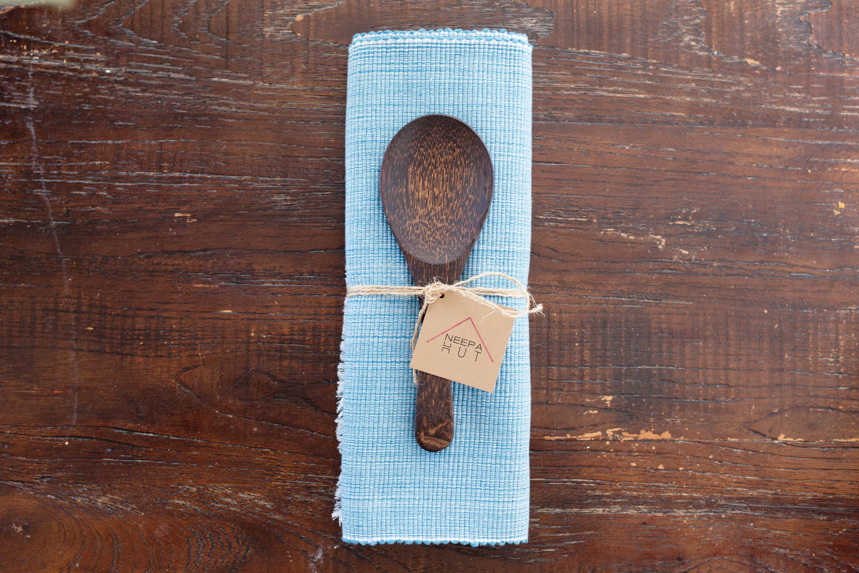 Handcrafted pastel blue woven cotton dining placemat featuring raised ribbed patterns, showcasing traditional Inabel fabric.