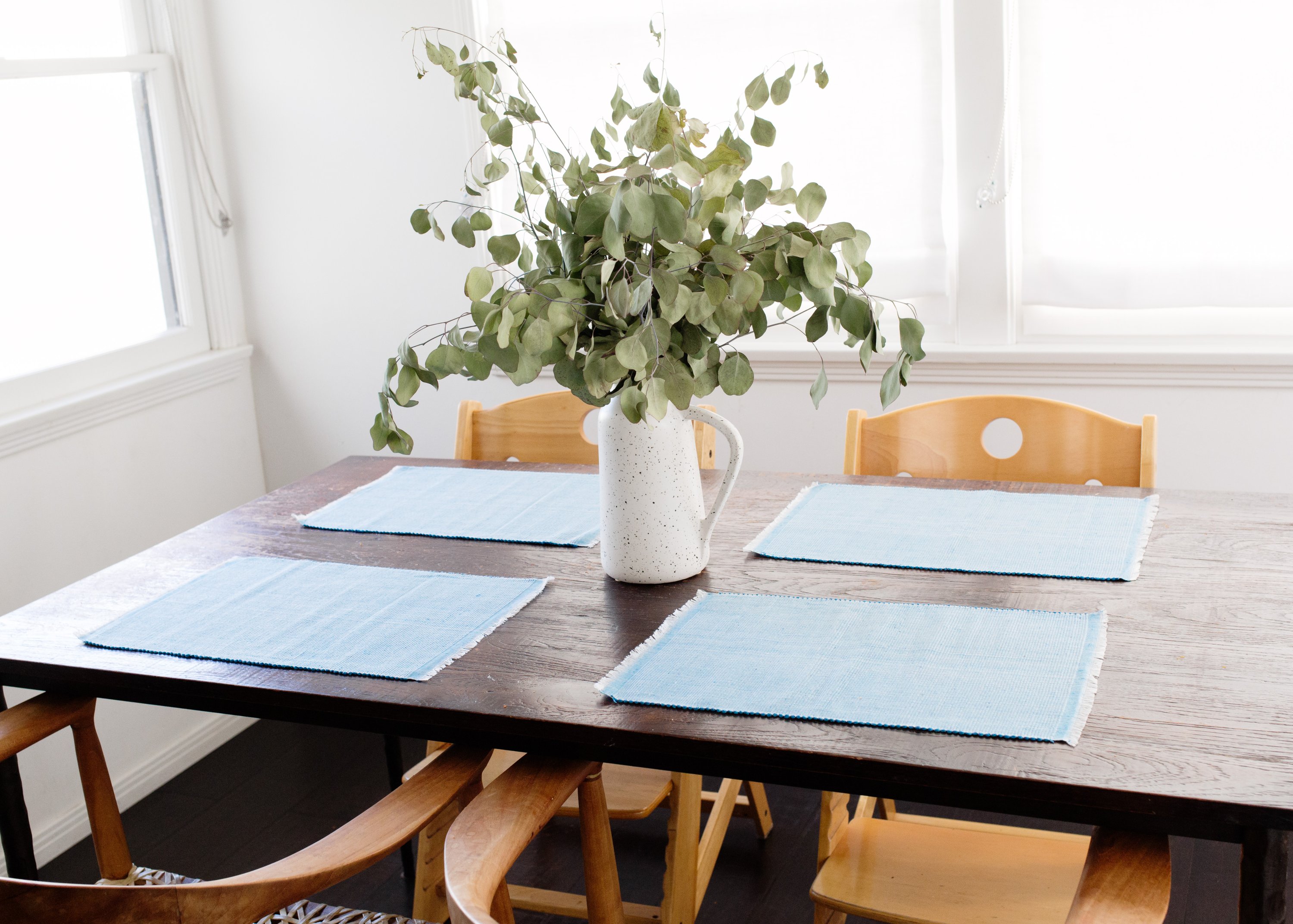 Handcrafted pastel blue woven cotton dining placemat featuring raised ribbed patterns, showcasing traditional Inabel fabric.