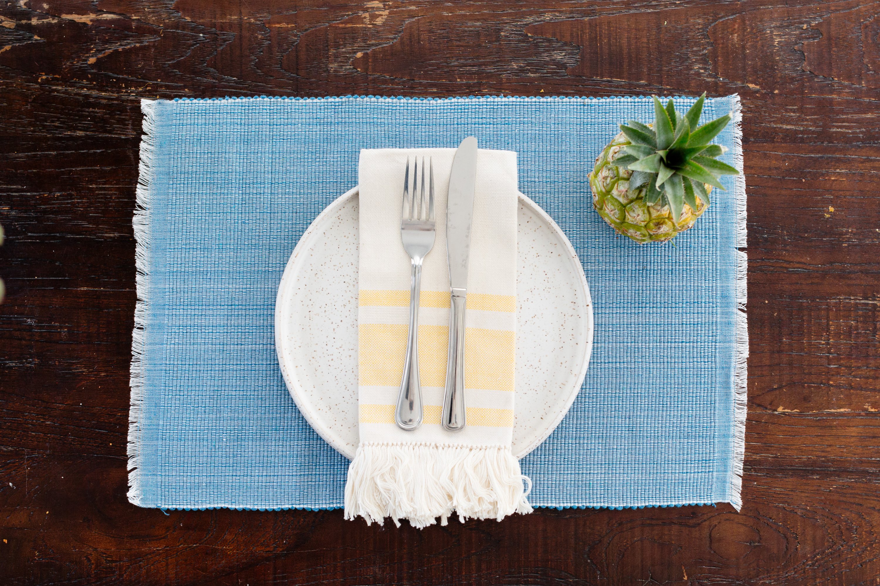 Handcrafted pastel blue woven dining placemat made from 100% cotton, featuring unique Inabel fabric and raised ribbed patterns.