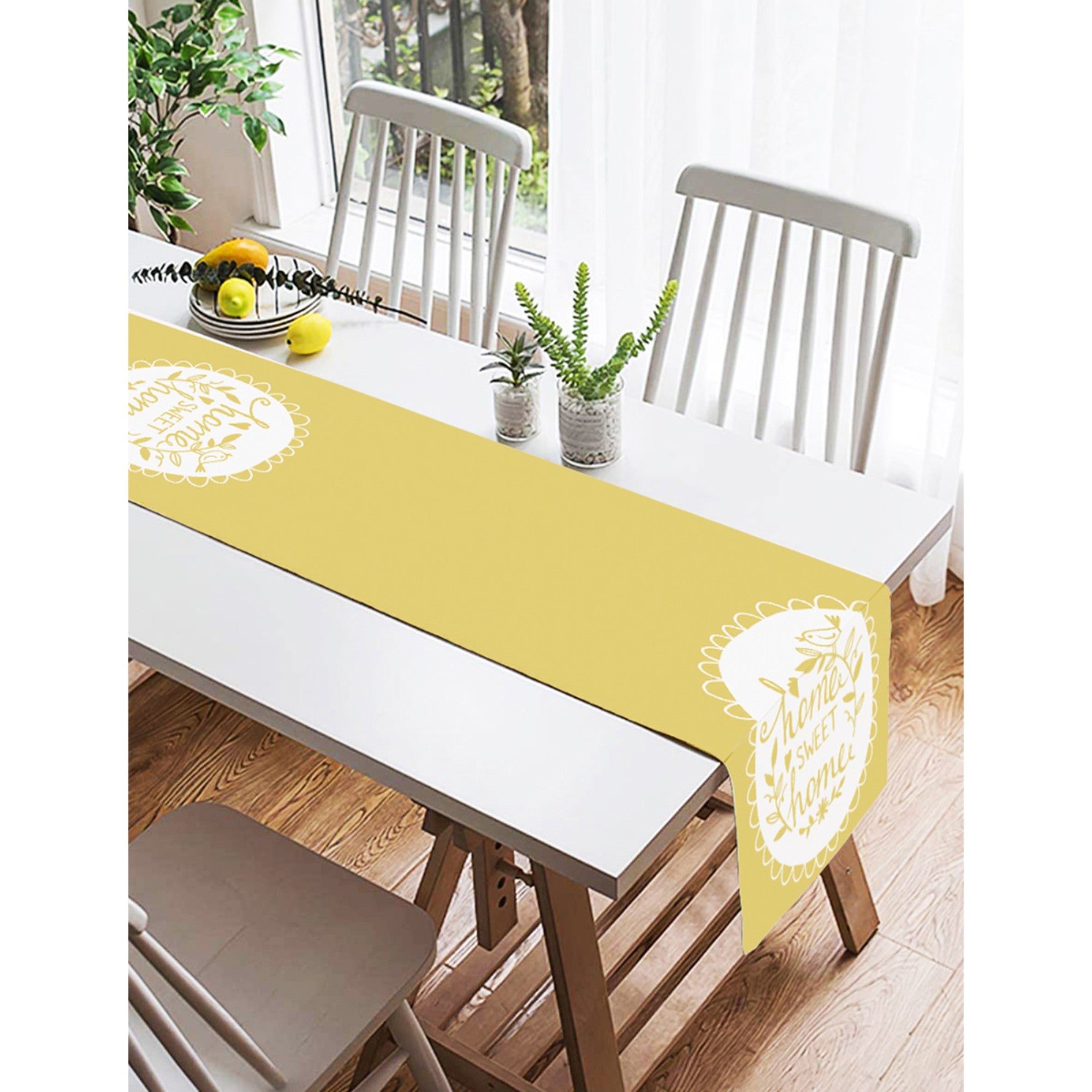 A vibrant yellow table runner with 'Home Sweet Home' printed design, showcasing vivid colors and high-quality fabric suitable for indoor and outdoor use.