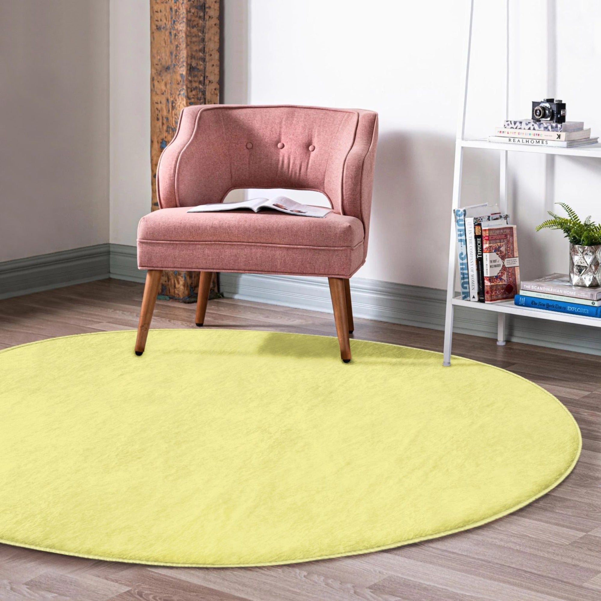 A vibrant yellow round rug made of soft velvet fabric, perfect for living room decor.