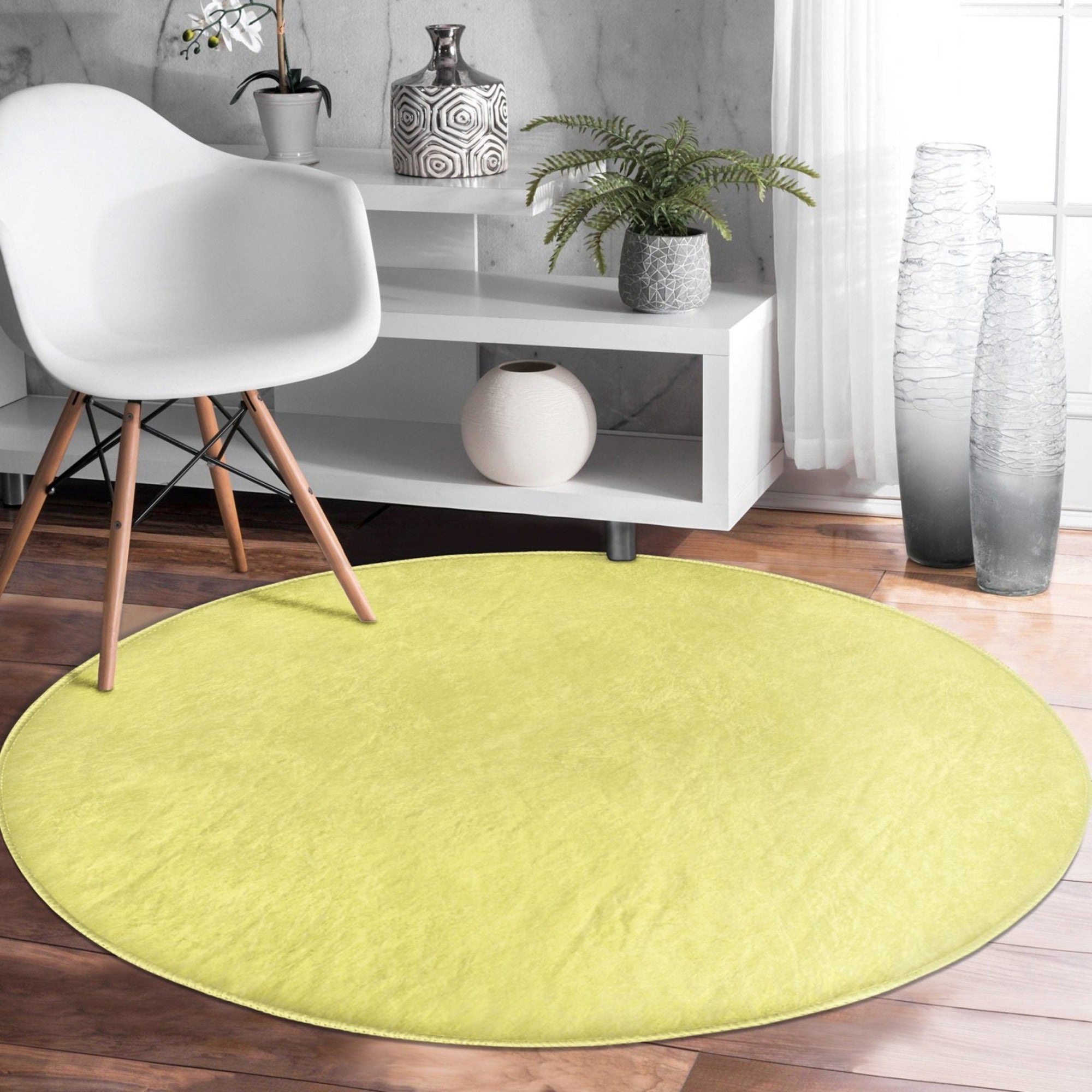 A vibrant yellow round rug made of soft velvet fabric, perfect for living room decor.