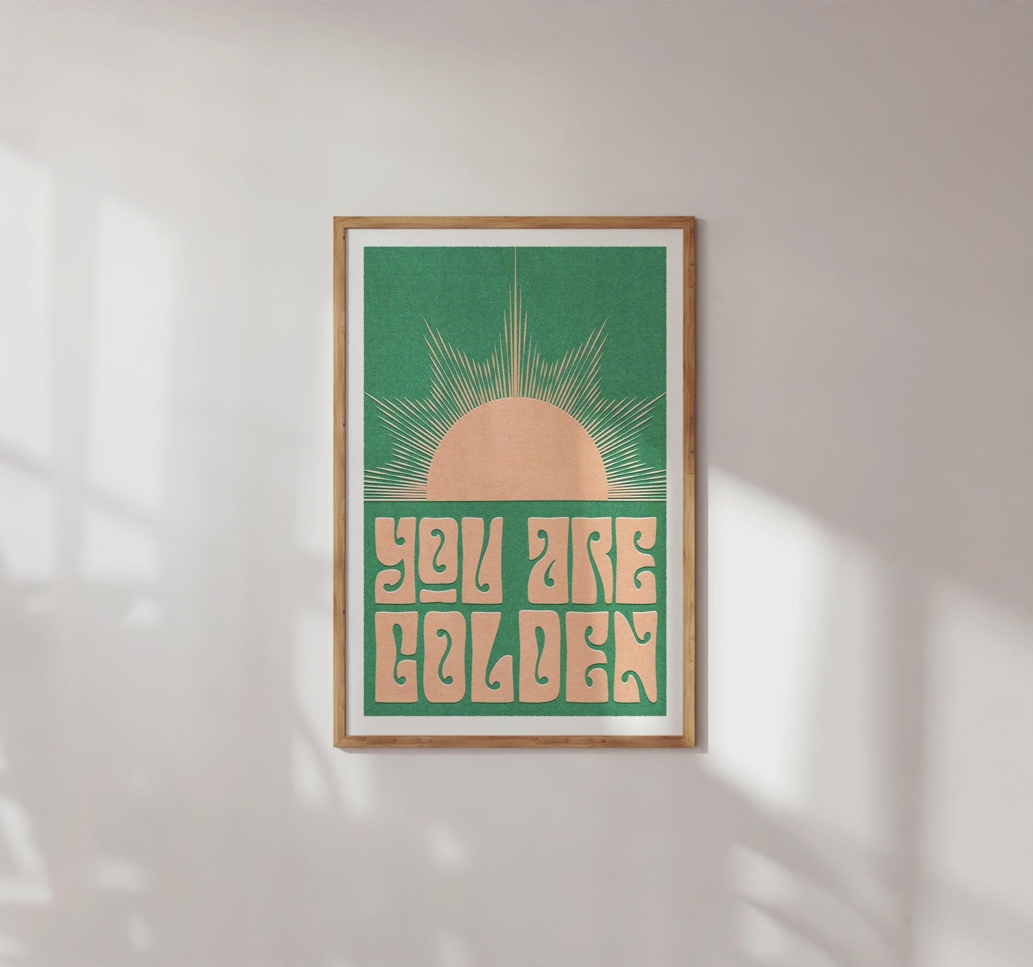 You Are Golden art print featuring retro typography and a minimal sun design in sepia and pink-green options.