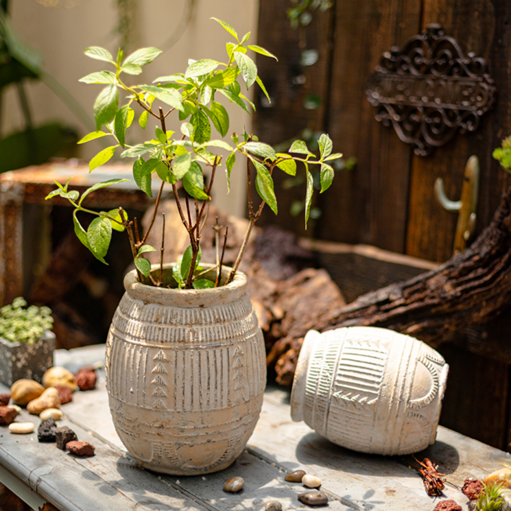 Yukun Terracotta Planter in tan and taupe, showcasing its handmade design and stoneware material.