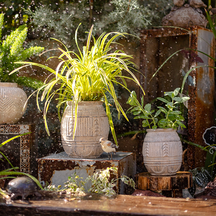 Yukun Terracotta Planter in tan and taupe, showcasing its handmade design and stoneware material.