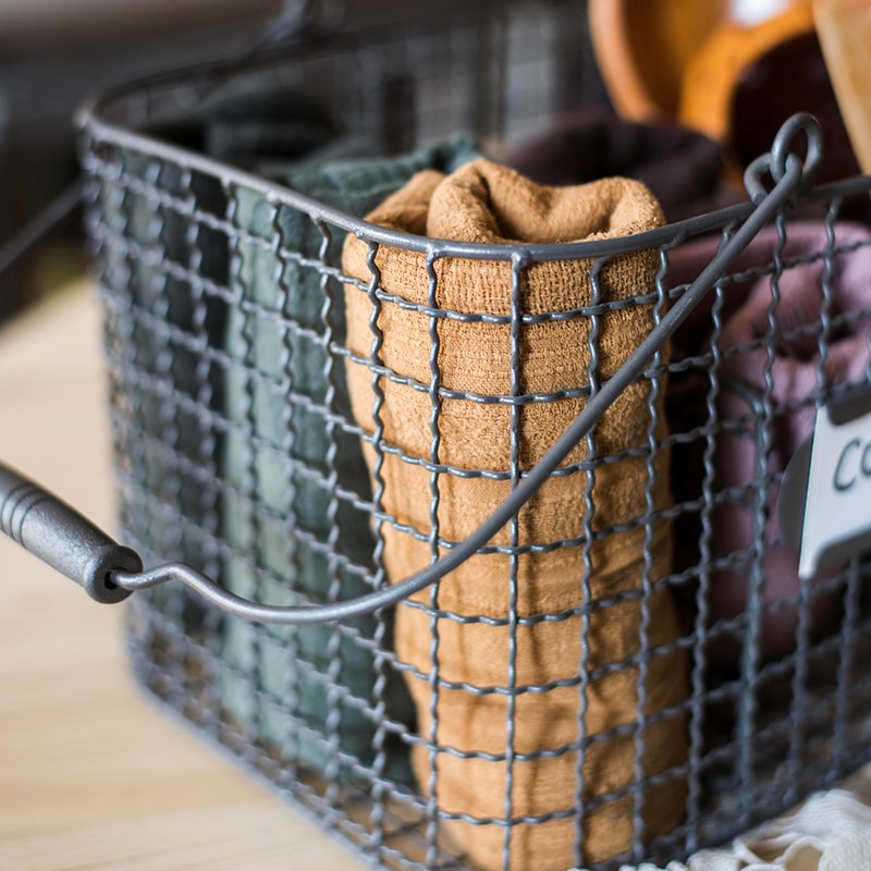 Zakka Multifunctional Wire Organizer Basket in dark gray and black, showcasing its compact design and sturdy handle.