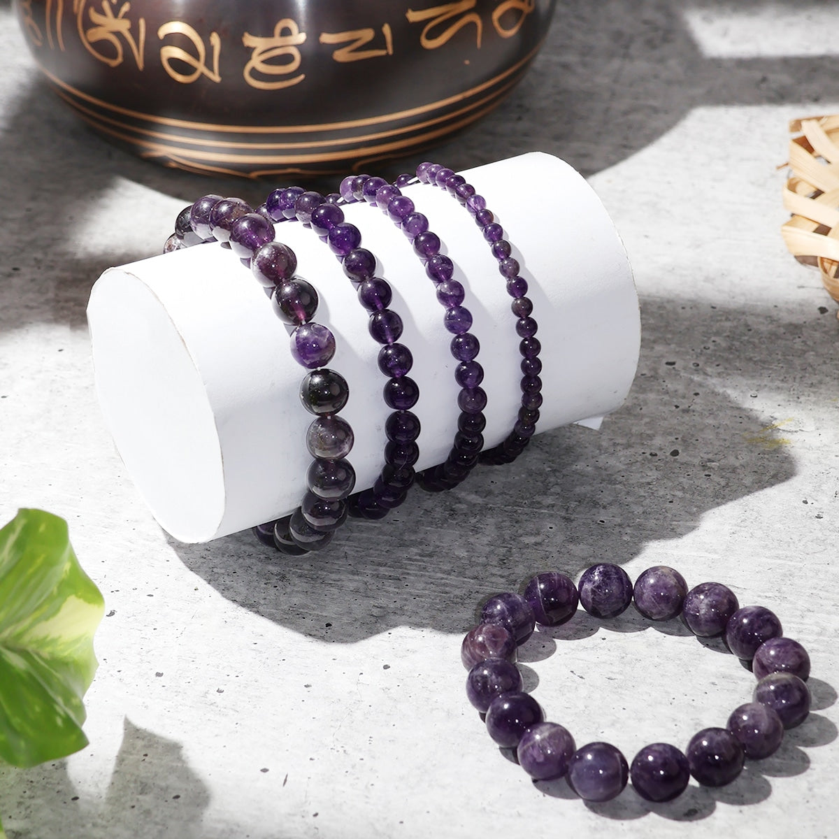 Amethyst Round Beads Bracelet showcasing natural purple crystals in various sizes, elegantly strung on an elastic band.