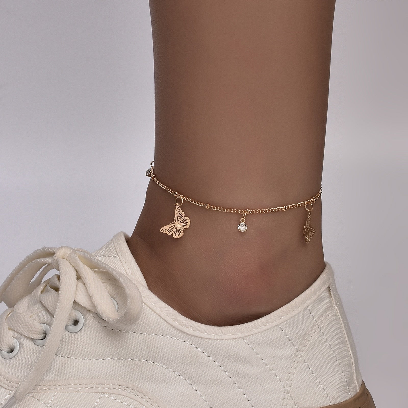 Boho Butterfly Charm Anklet in gold and silver, featuring a delicate butterfly design, adjustable length, and elegant packaging.