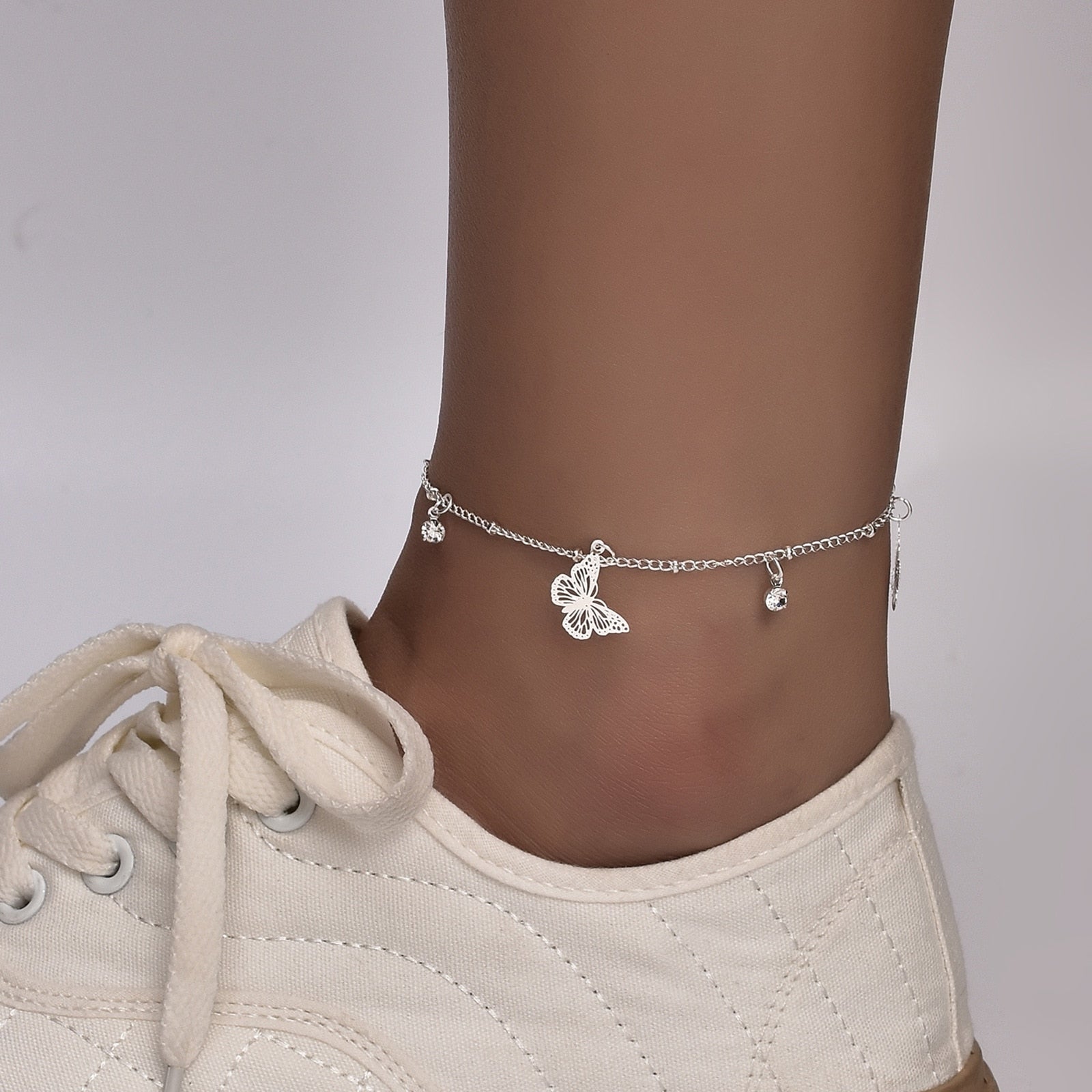 Boho Butterfly Charm Anklet in gold and silver, featuring a delicate butterfly design, adjustable length, and elegant packaging.