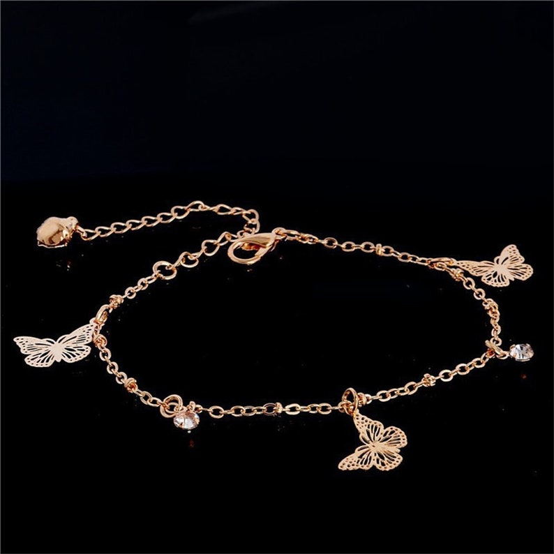 Boho Butterfly Charm Anklet in gold and silver, featuring a delicate butterfly design, adjustable length, and elegant packaging.