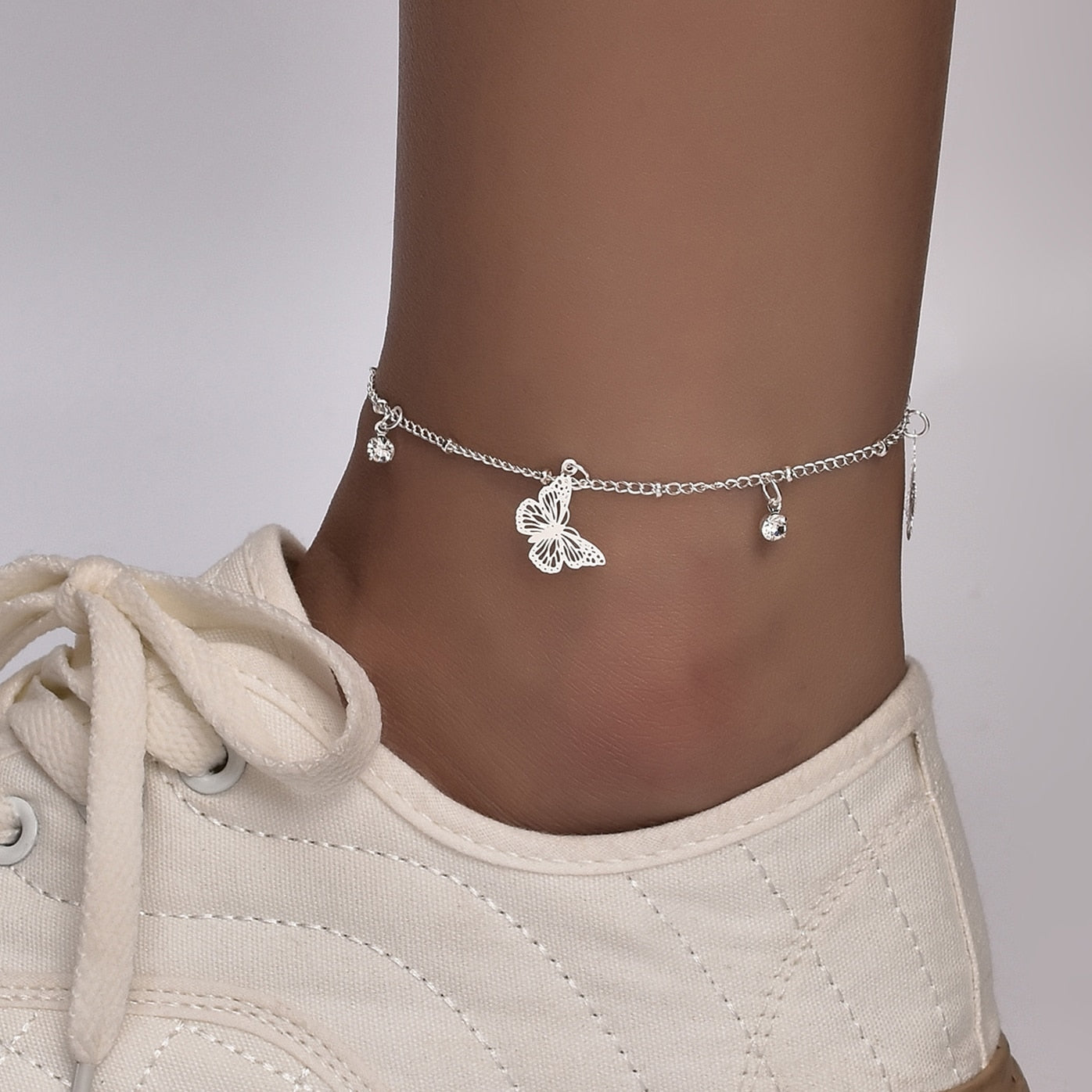 Boho Butterfly Charm Anklet in gold and silver, featuring a delicate butterfly design, adjustable length, and elegant packaging.