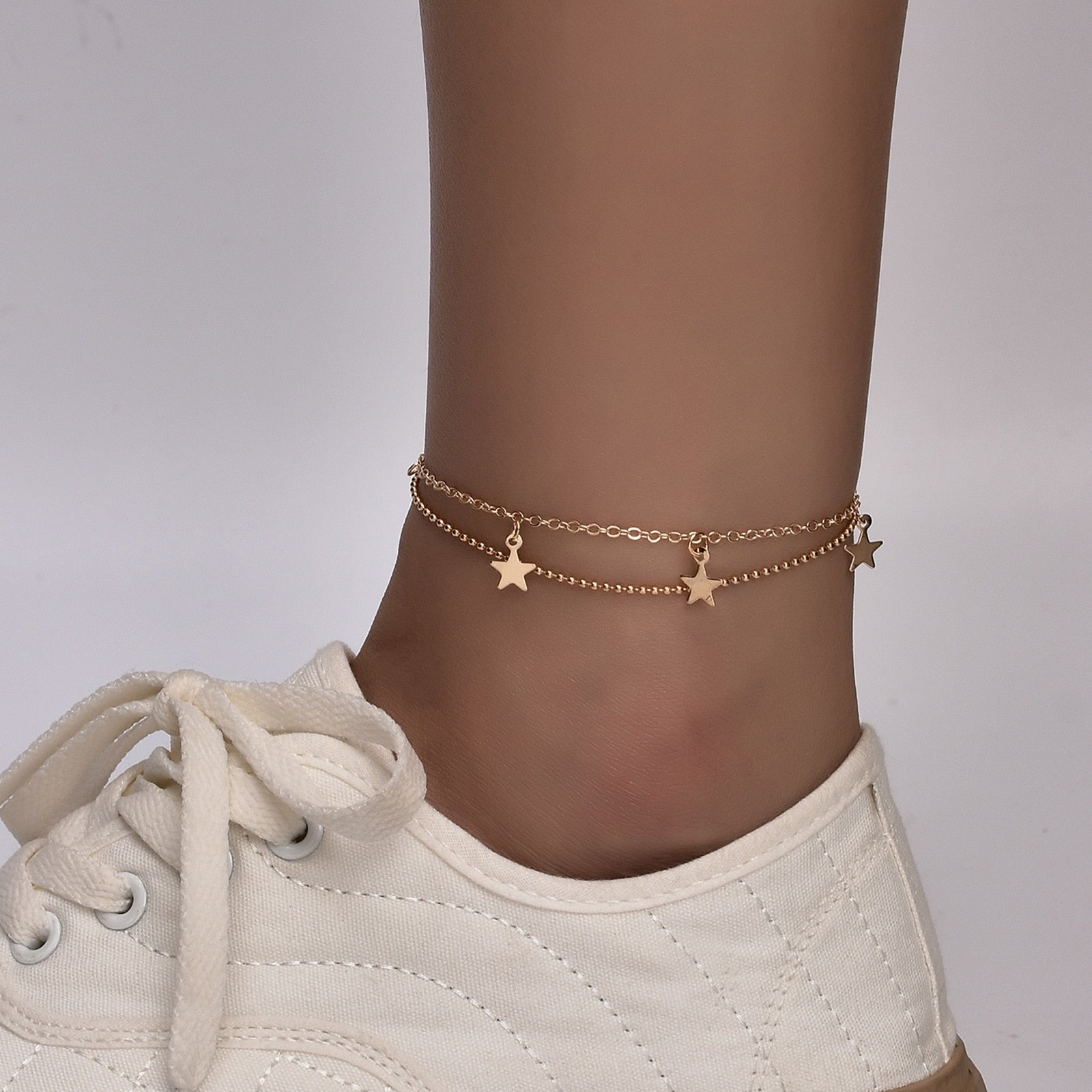 Boho Butterfly Charm Anklet in gold and silver, featuring a delicate butterfly design, adjustable length, and elegant packaging.