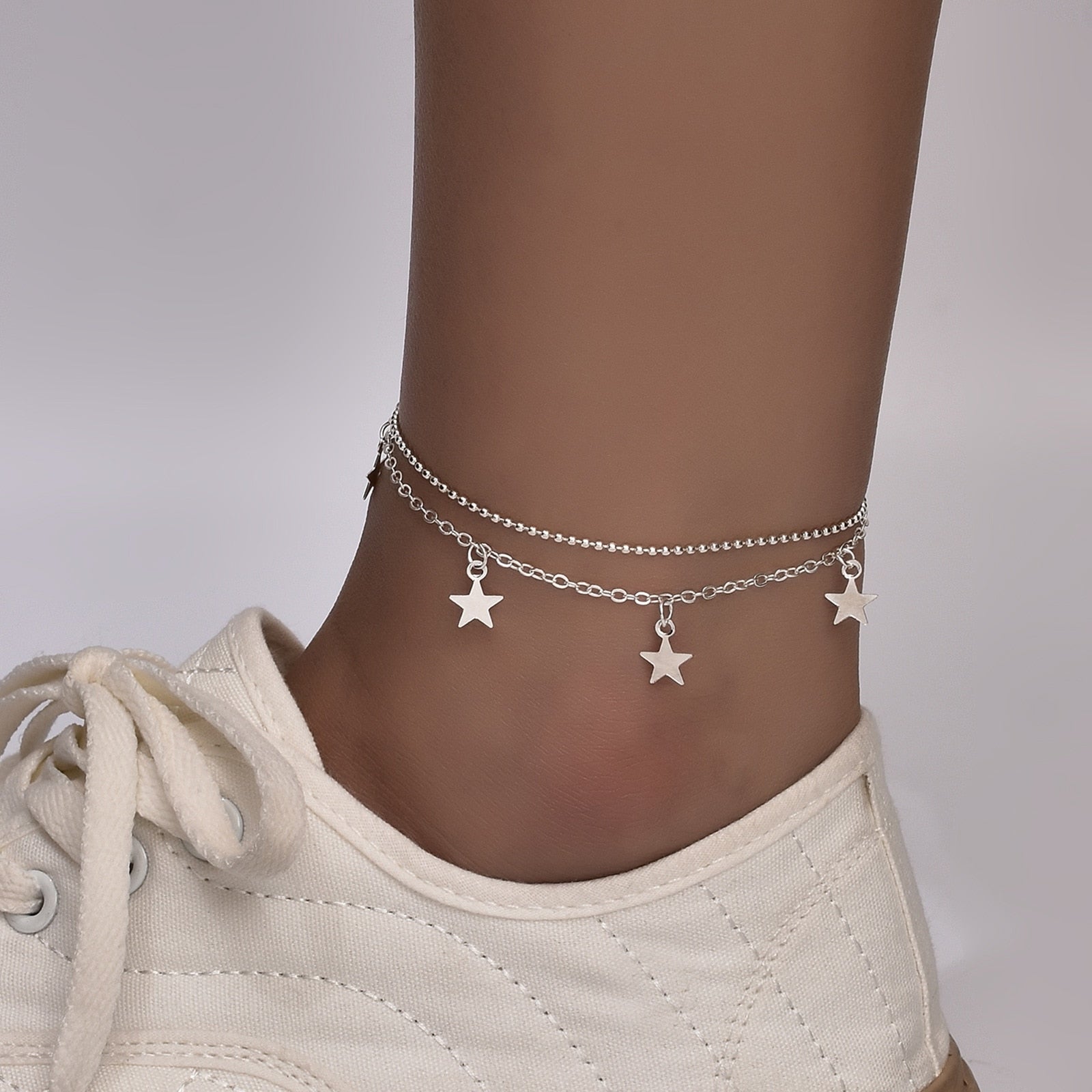 Boho Butterfly Charm Anklet in gold and silver, featuring a delicate butterfly design, adjustable length, and elegant packaging.