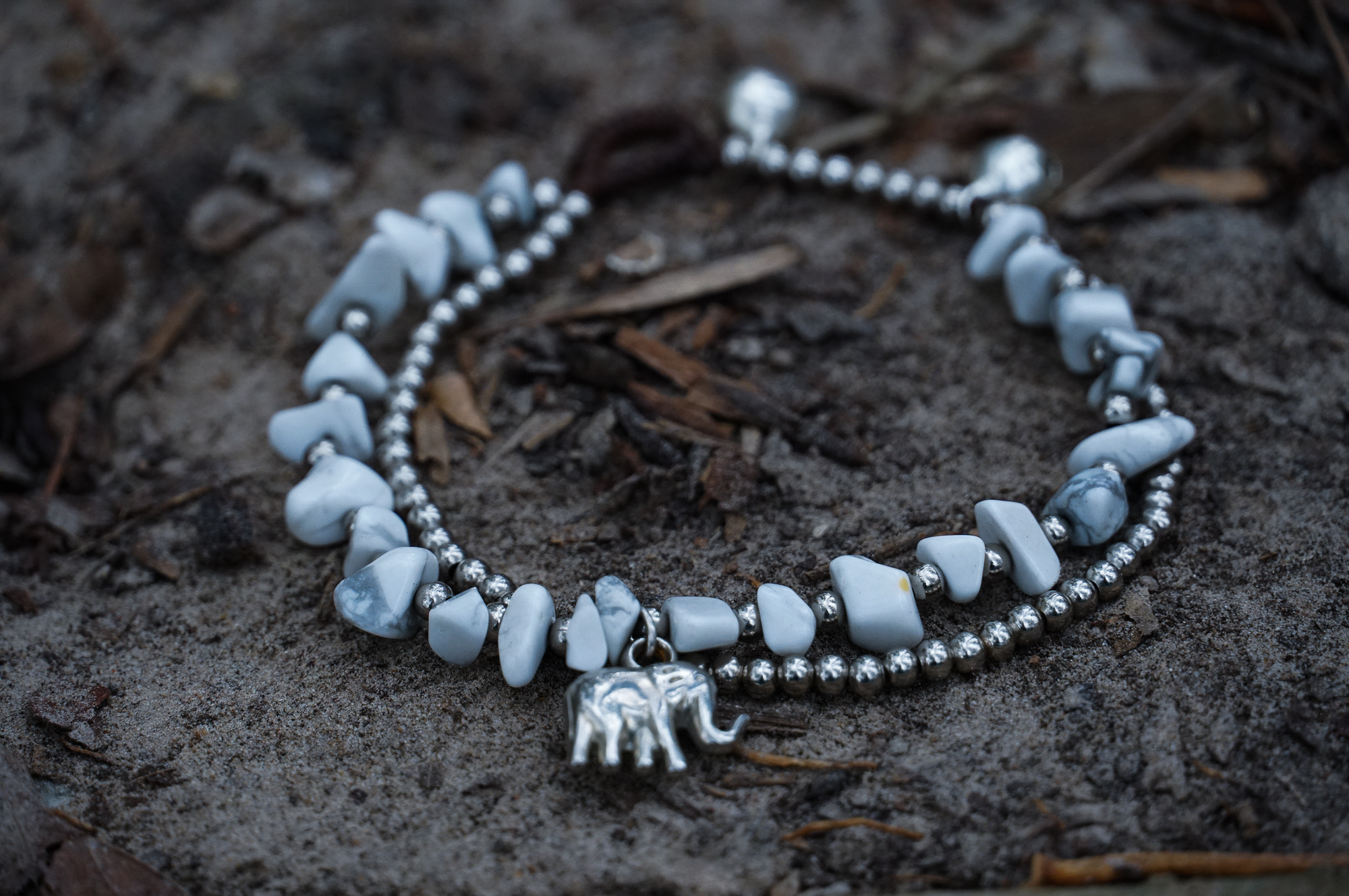 A beautifully handcrafted Boho Elephant Silver Stone Bracelet featuring elephant silver, natural stones, and pressed cotton cord, showcasing a unique bohemian design.