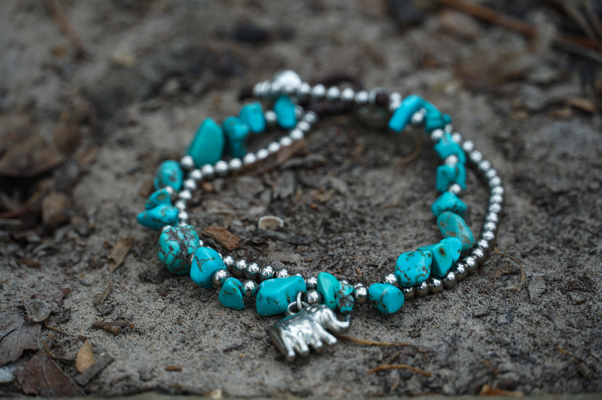 A beautifully handcrafted Boho Elephant Silver Stone Bracelet featuring elephant silver, natural stones, and pressed cotton cord, showcasing a unique bohemian design.