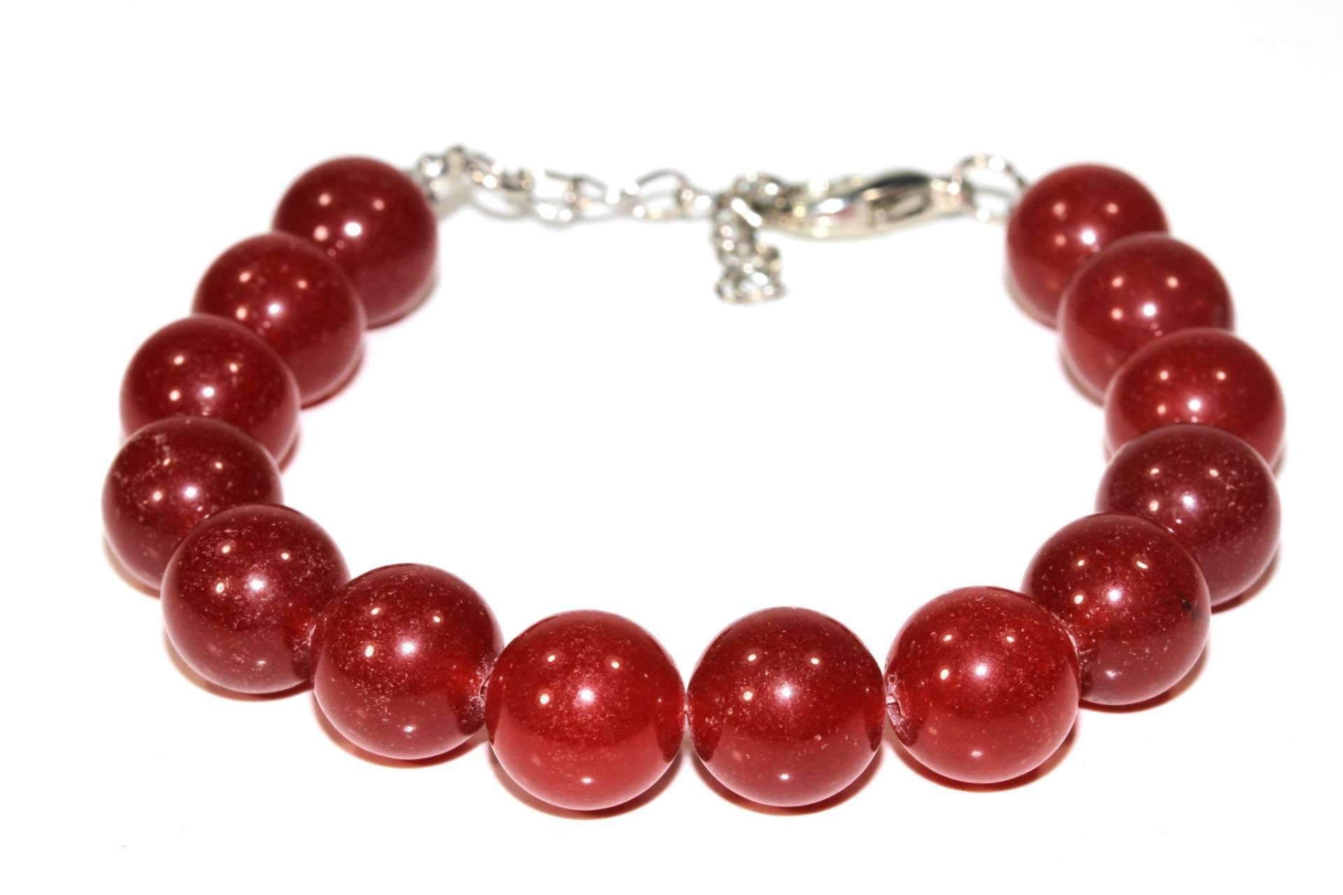 A vibrant red carnelian yoga bracelet with round beads and a silver tone lobster clasp, showcasing its handmade quality.