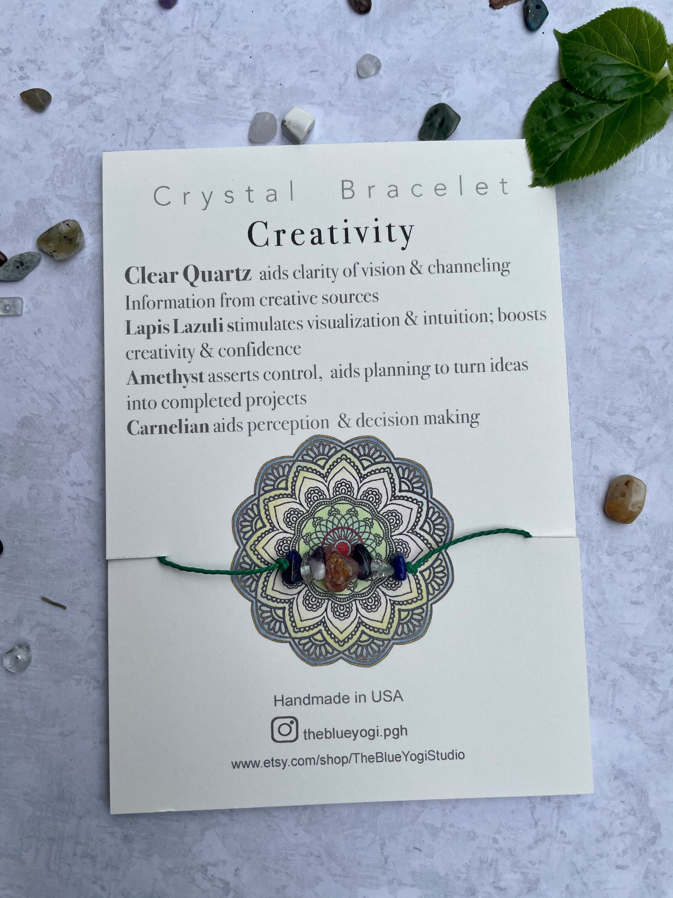 A handcrafted Creativity Bracelet featuring natural gemstones with a tie closure, displayed alongside a watercolor Mandala art card.